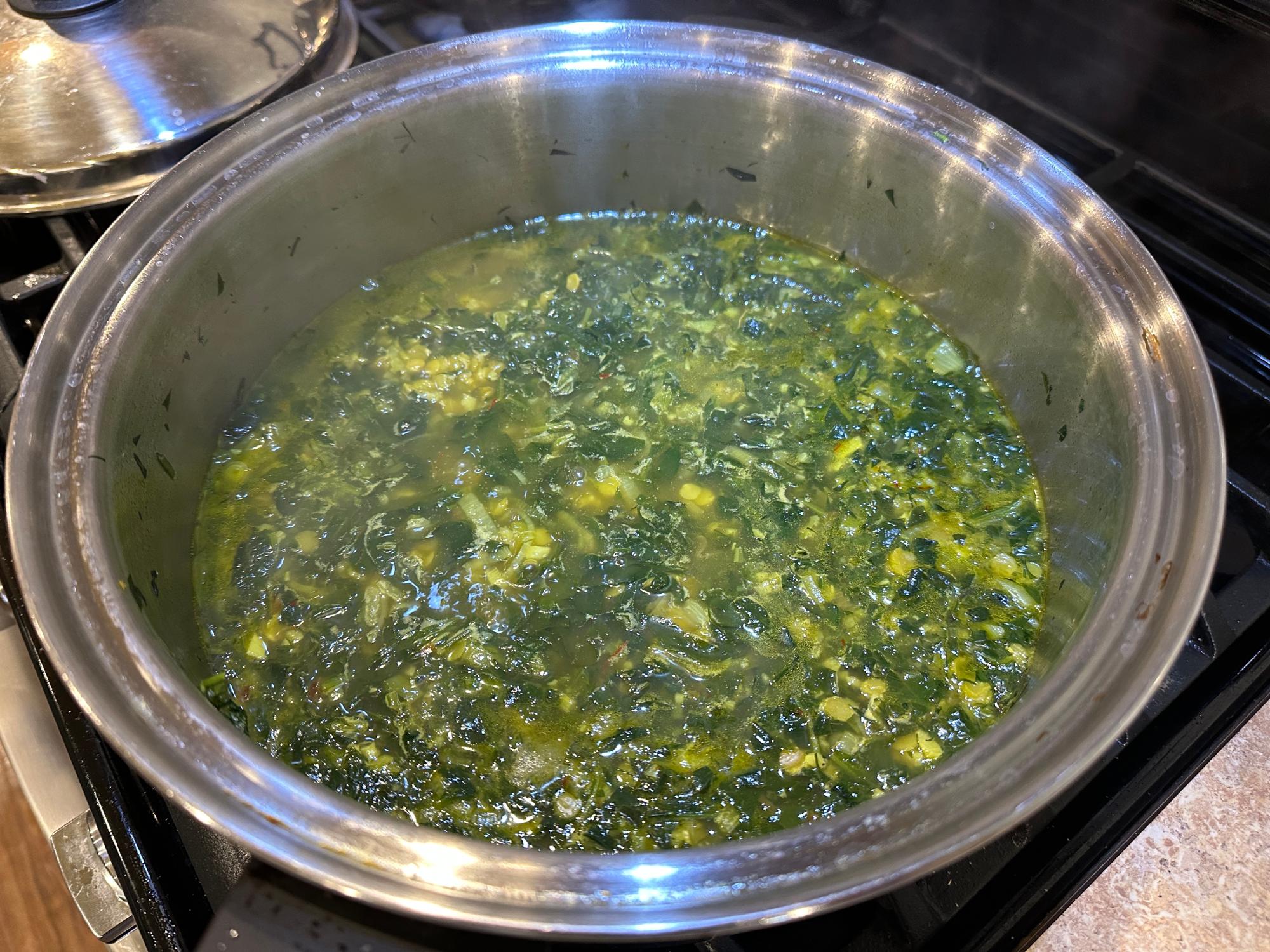 Greens cooking in the pot.