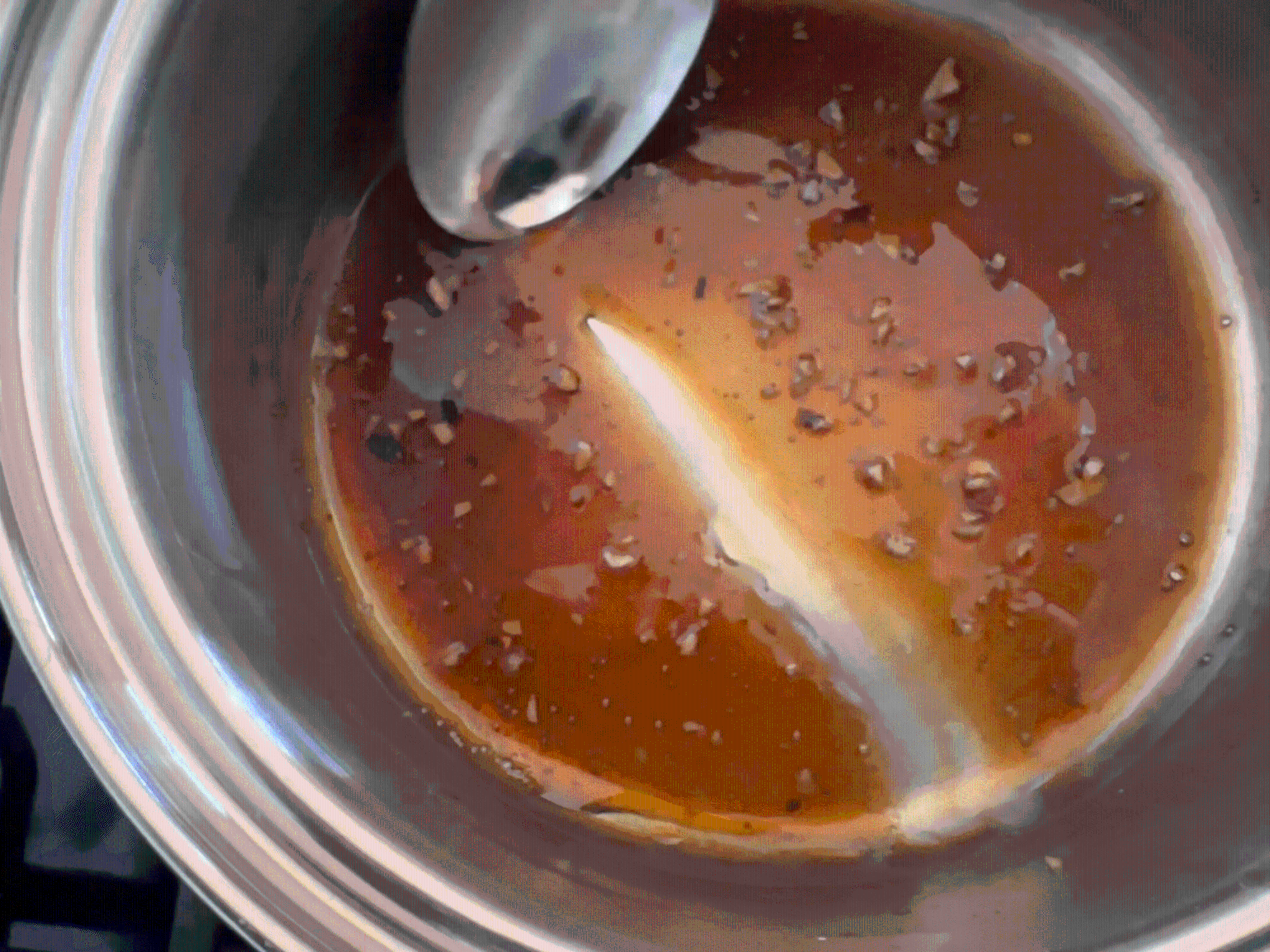 Running a spoon through the sauce.