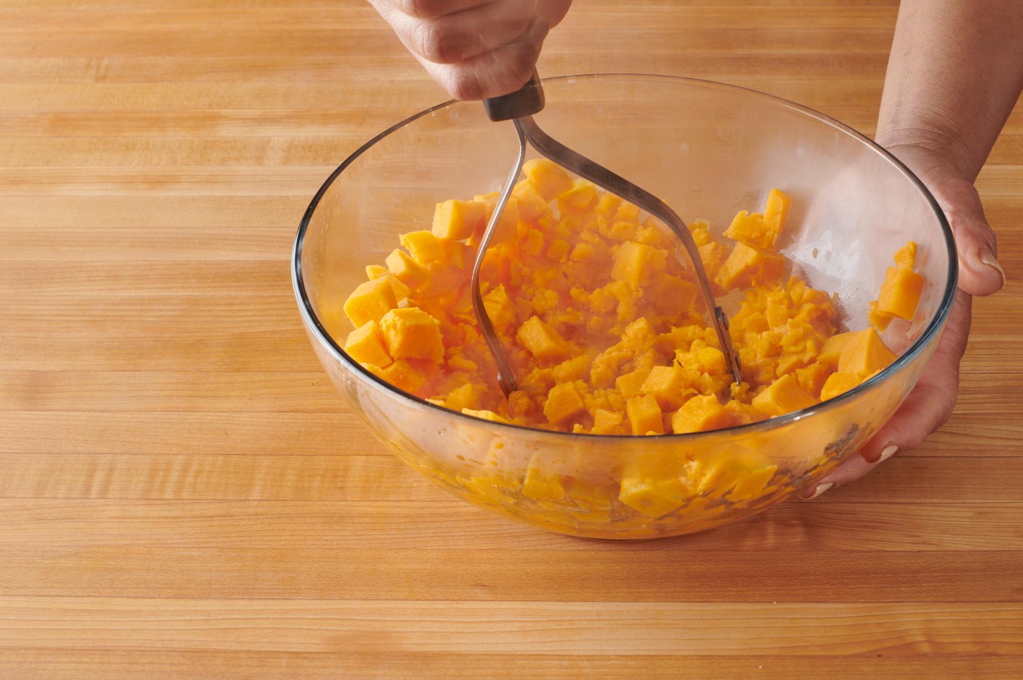 Mashing to sweet potatoes with a Potato Masher.