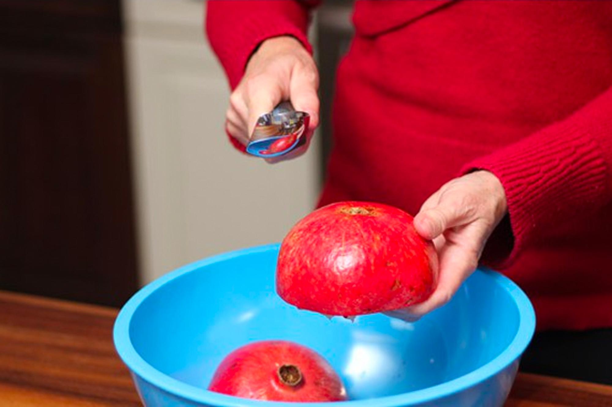 Use an ice cream scoop to remove the seeds from a pomegranate.