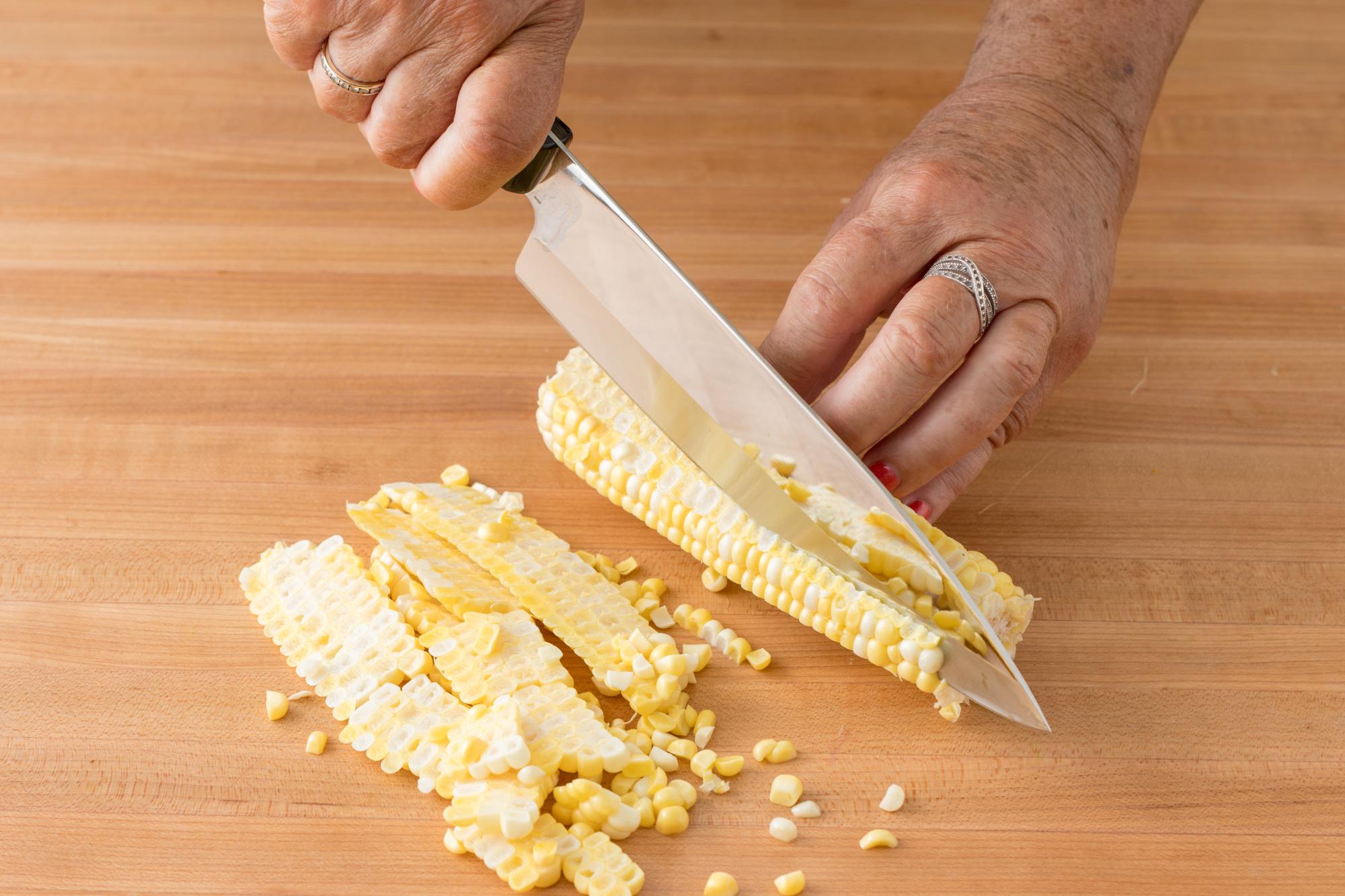 Cutting the corn off the cob with a Petite Chef.