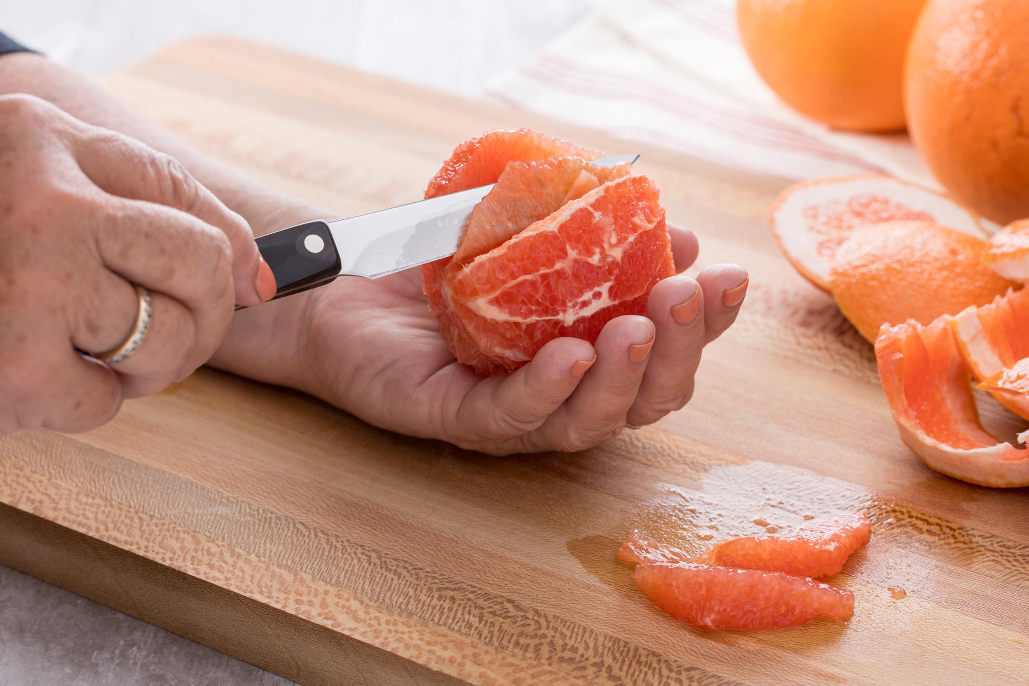 Slicing the grapefruit with a 4 Inch Gourmet Paring Knife.