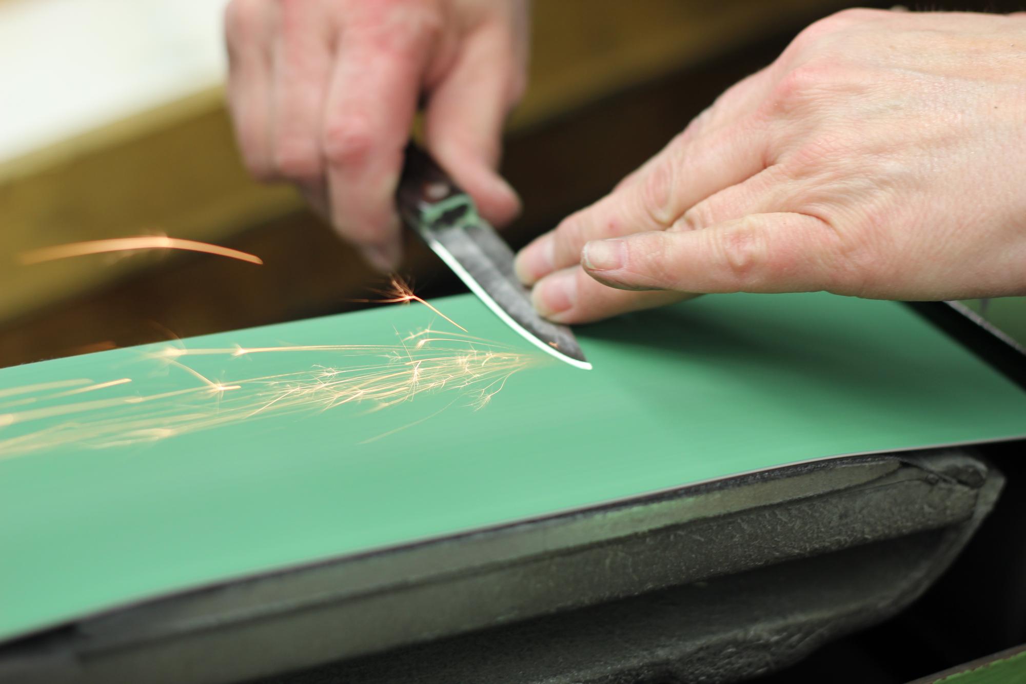 Honing a knife in our factory.