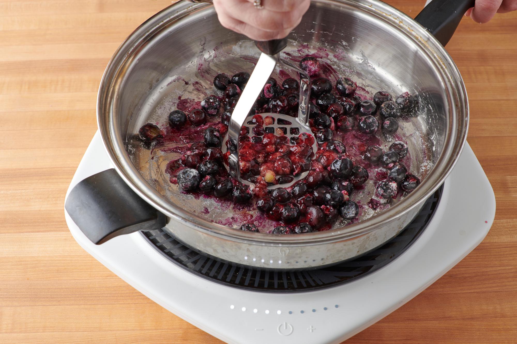 Use the Potato Masher to mash down the blueberries.