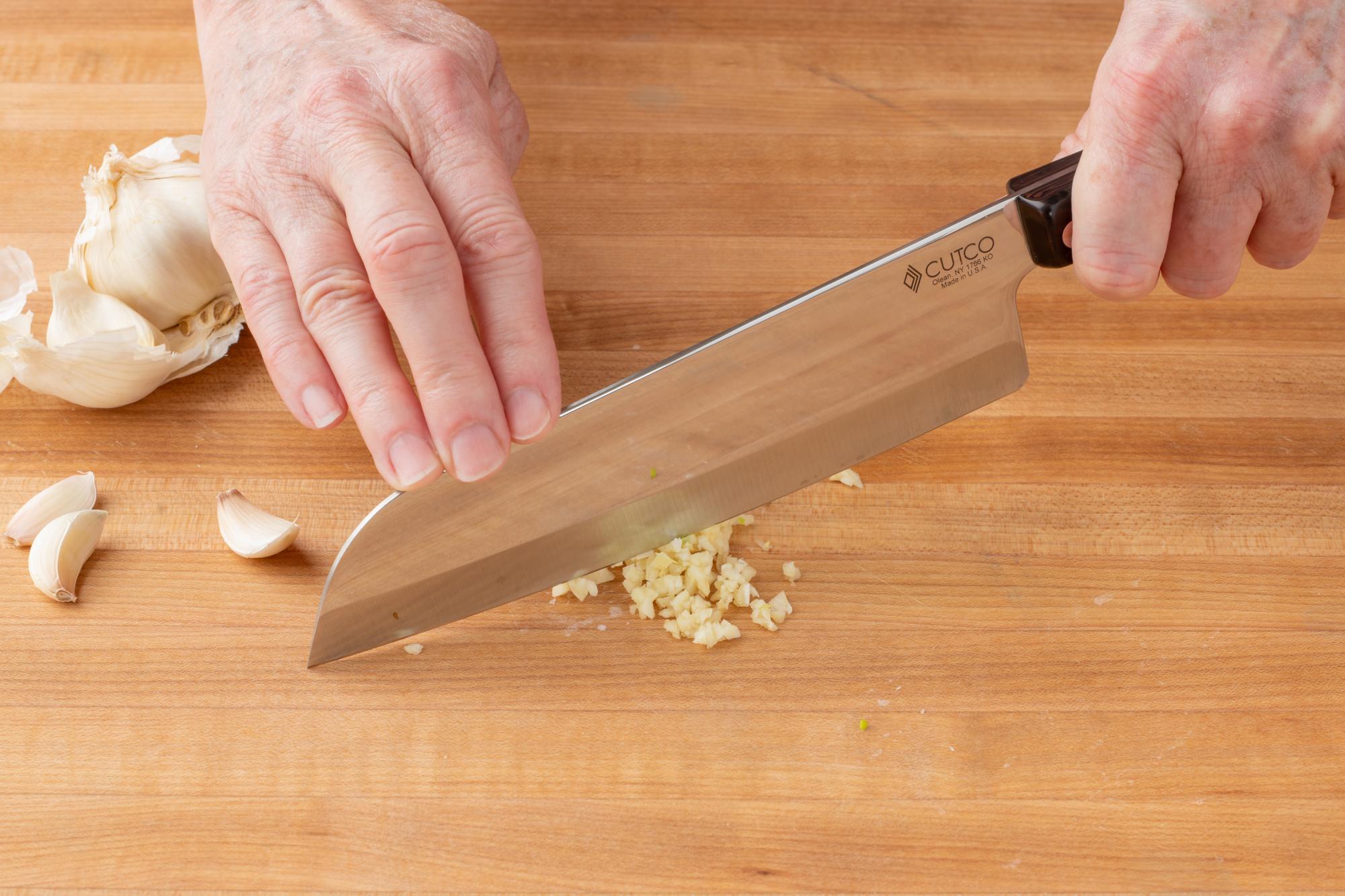 Mincing the garlic with a Santoku.