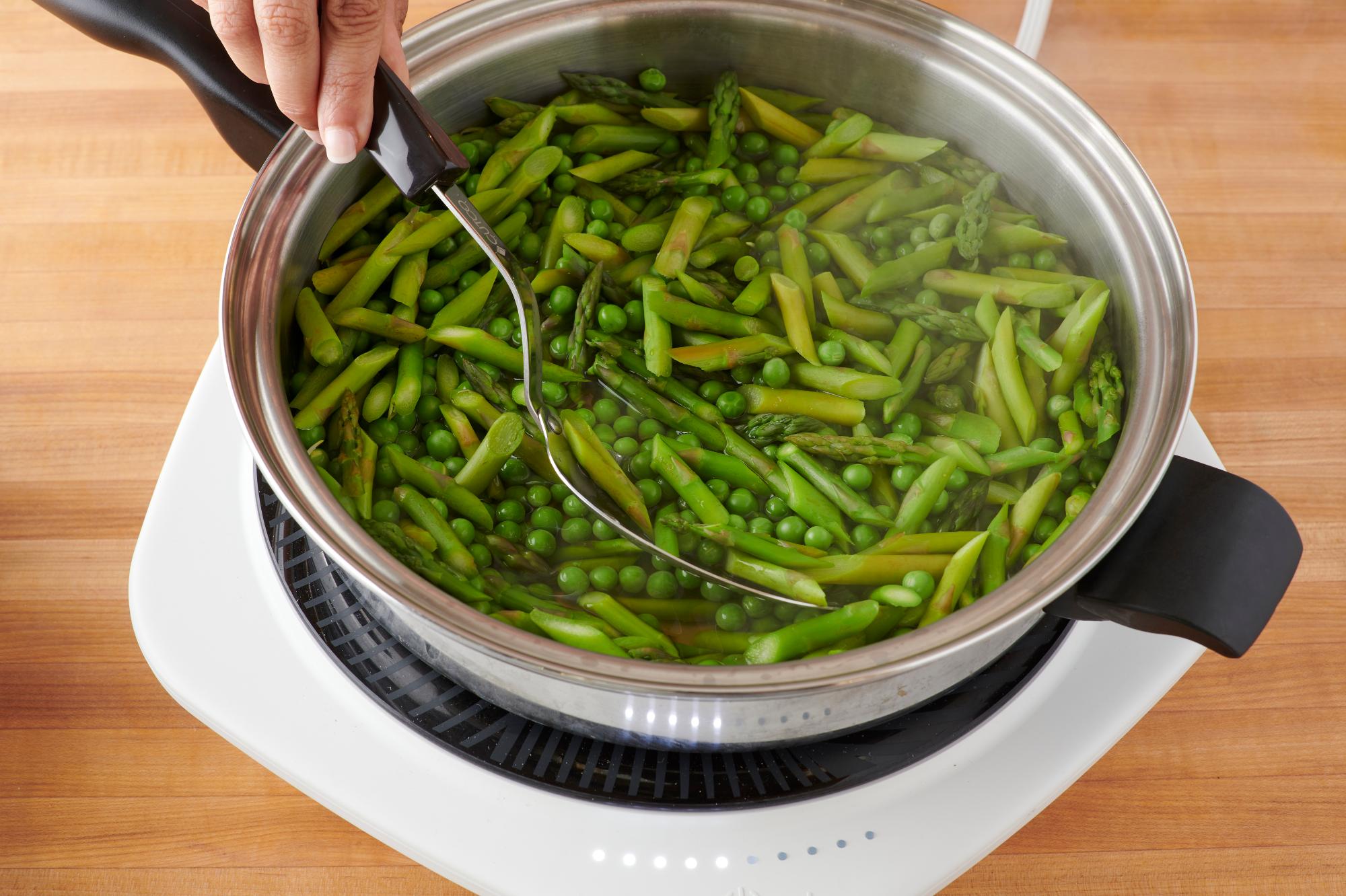 Cooking the peas and asparagus.