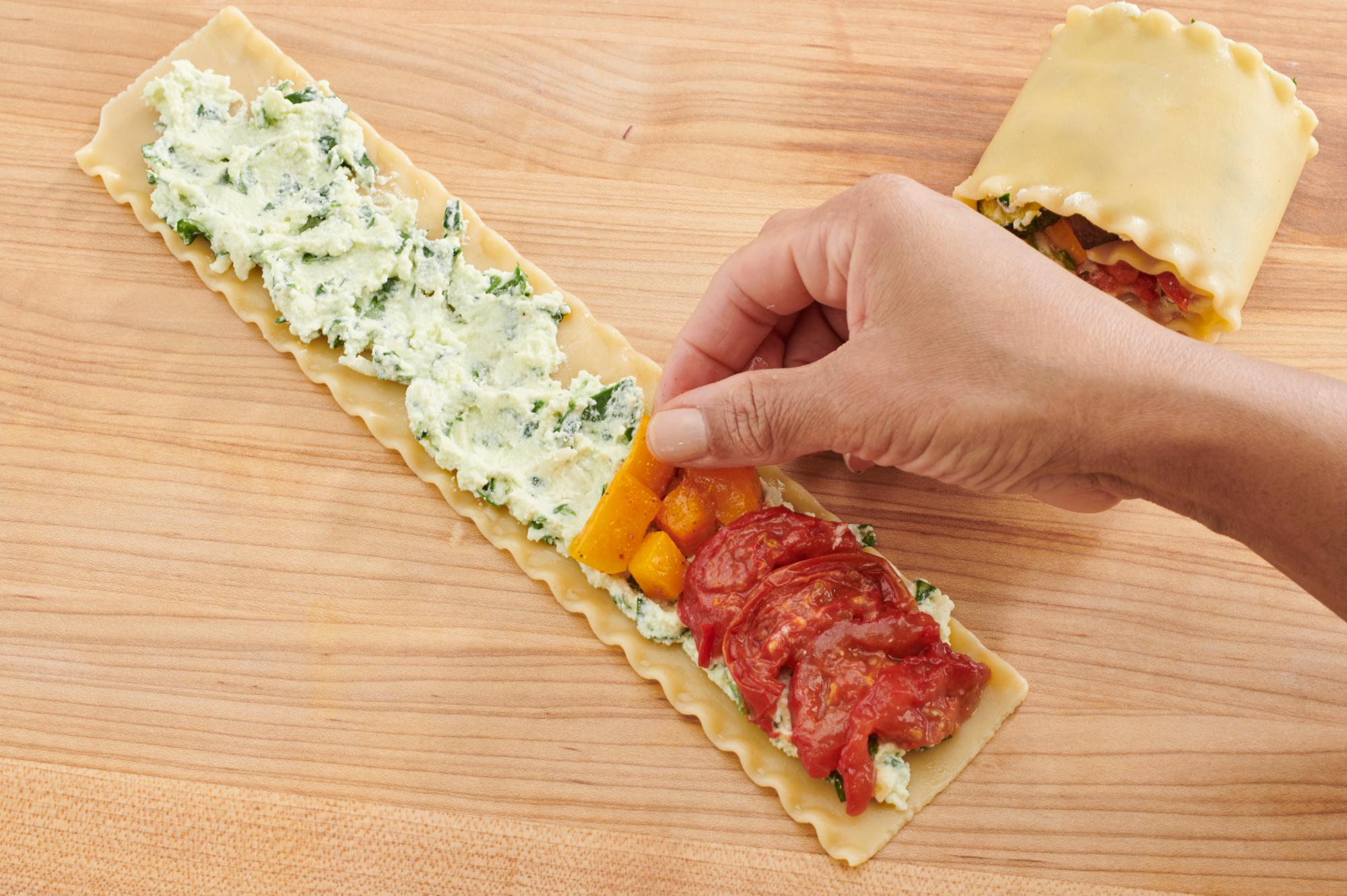 Placing vegetables on the noodles.