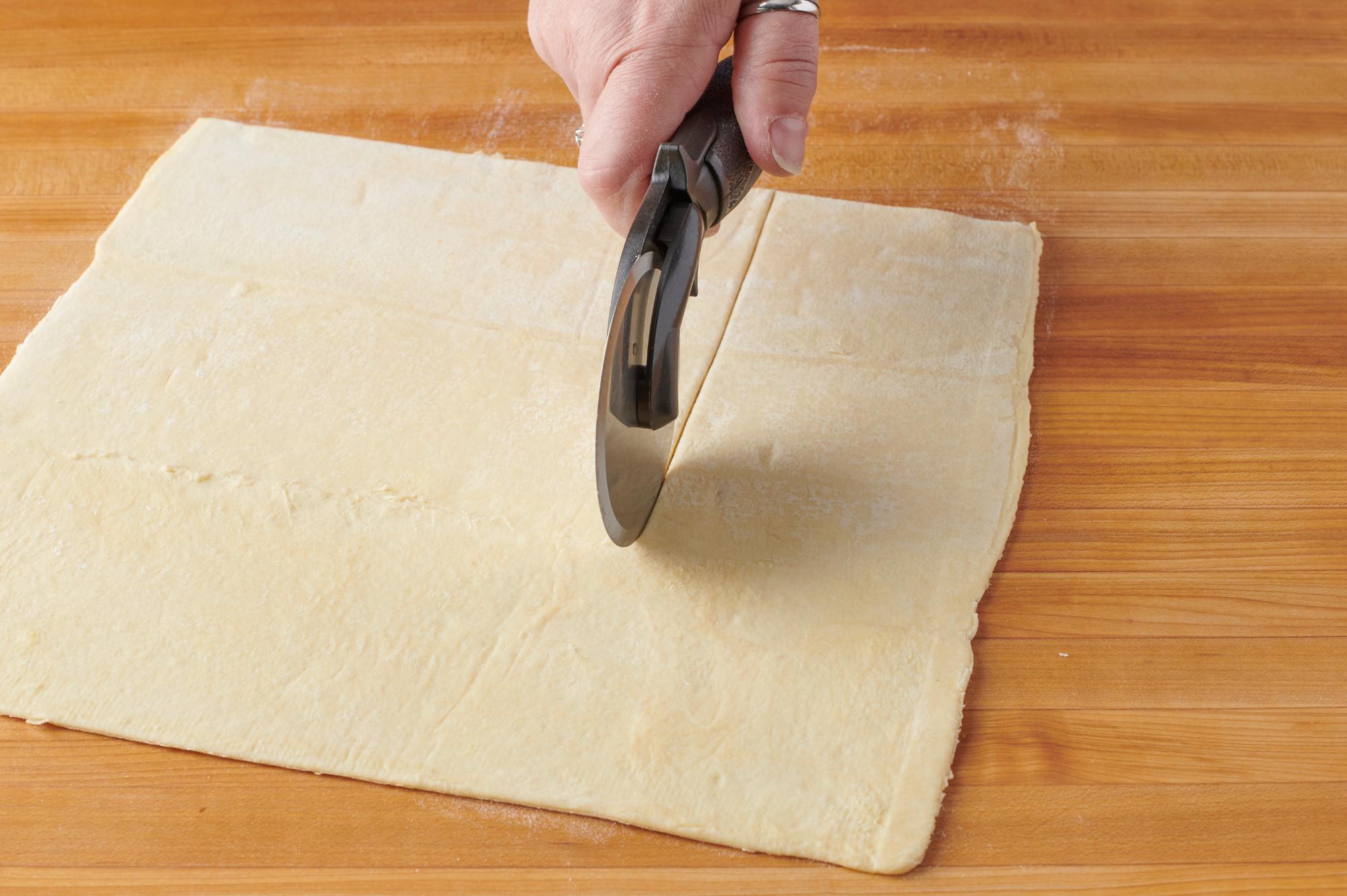 Cutting the dough with a Pizza Cutter
