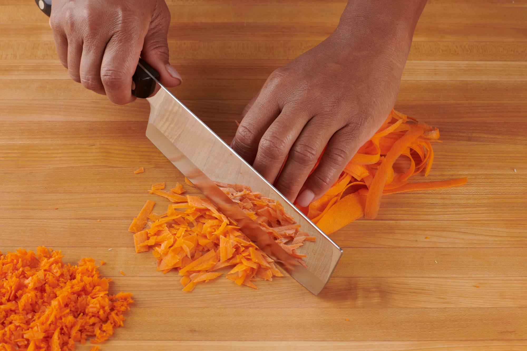 Chopping carrots with a Vegetable Knife.