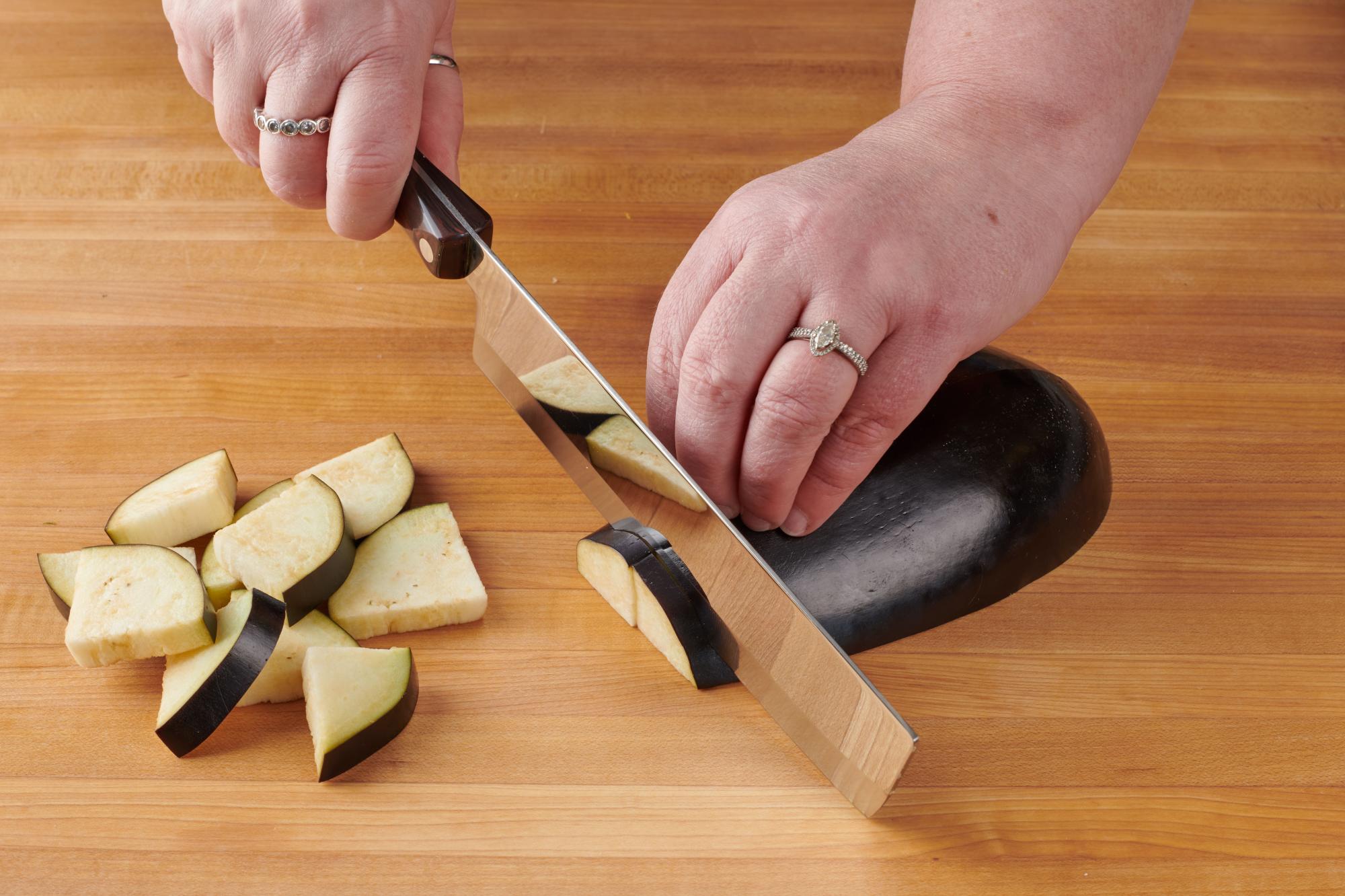 Cutting the eggplant with a Vegetable Knife.