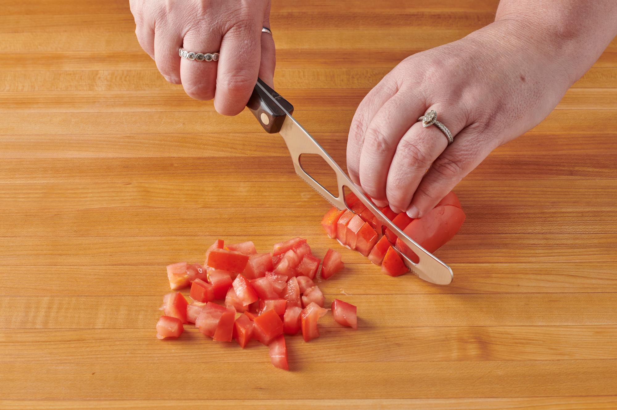 Cutting the tomato with a Traditional Cheese Knife.