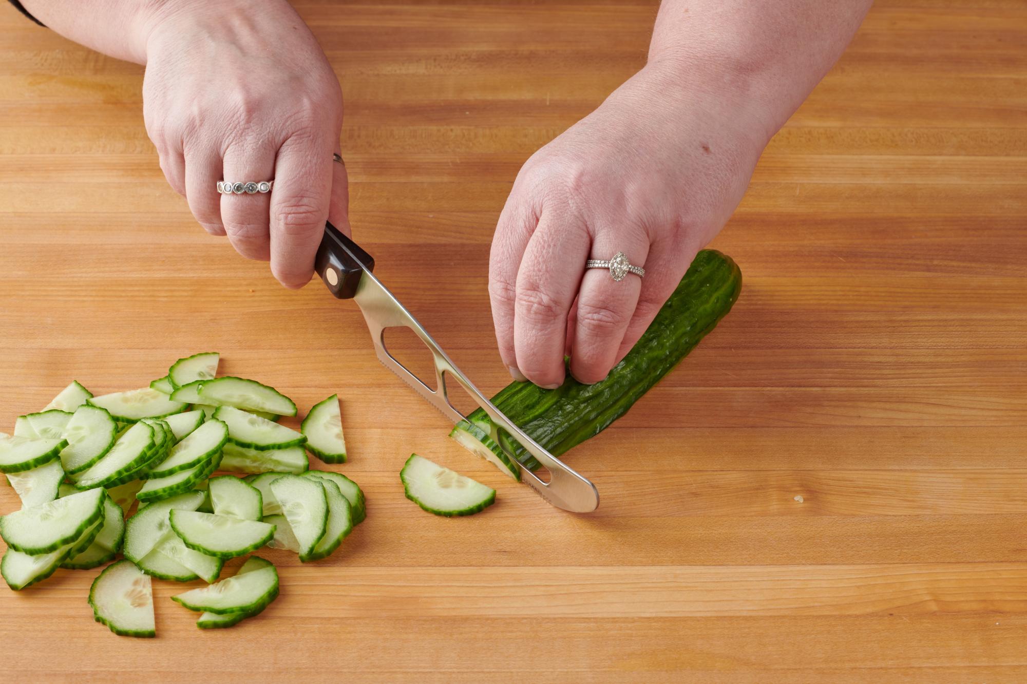 Cutting a cucumber with a Traditional Cheese Knife.