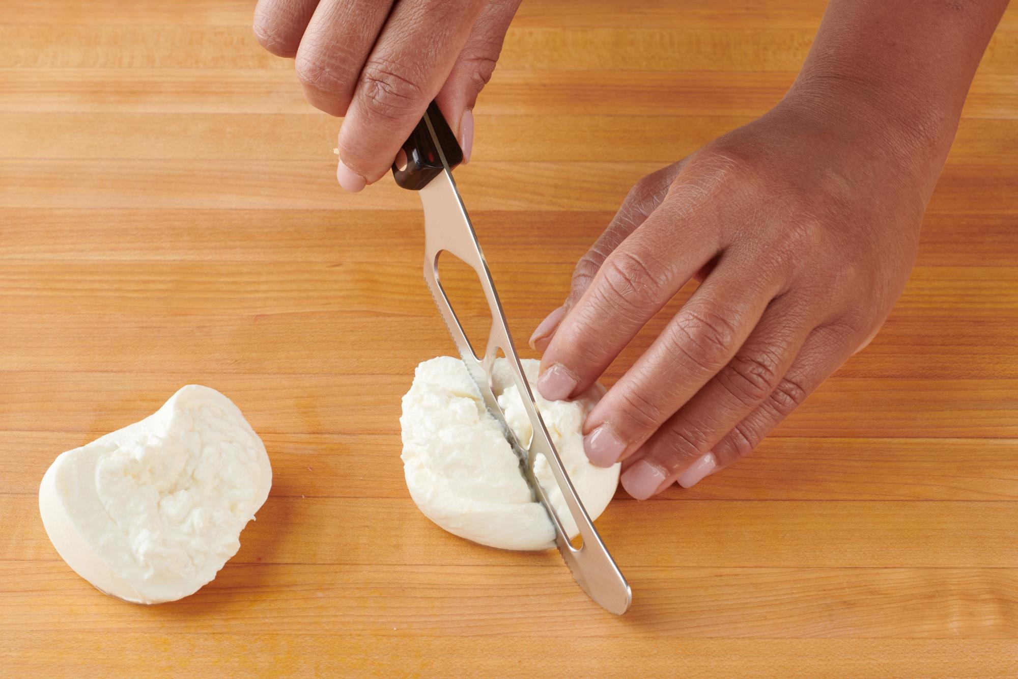 Slicing the burrata with a Traditional Cheese Knife.