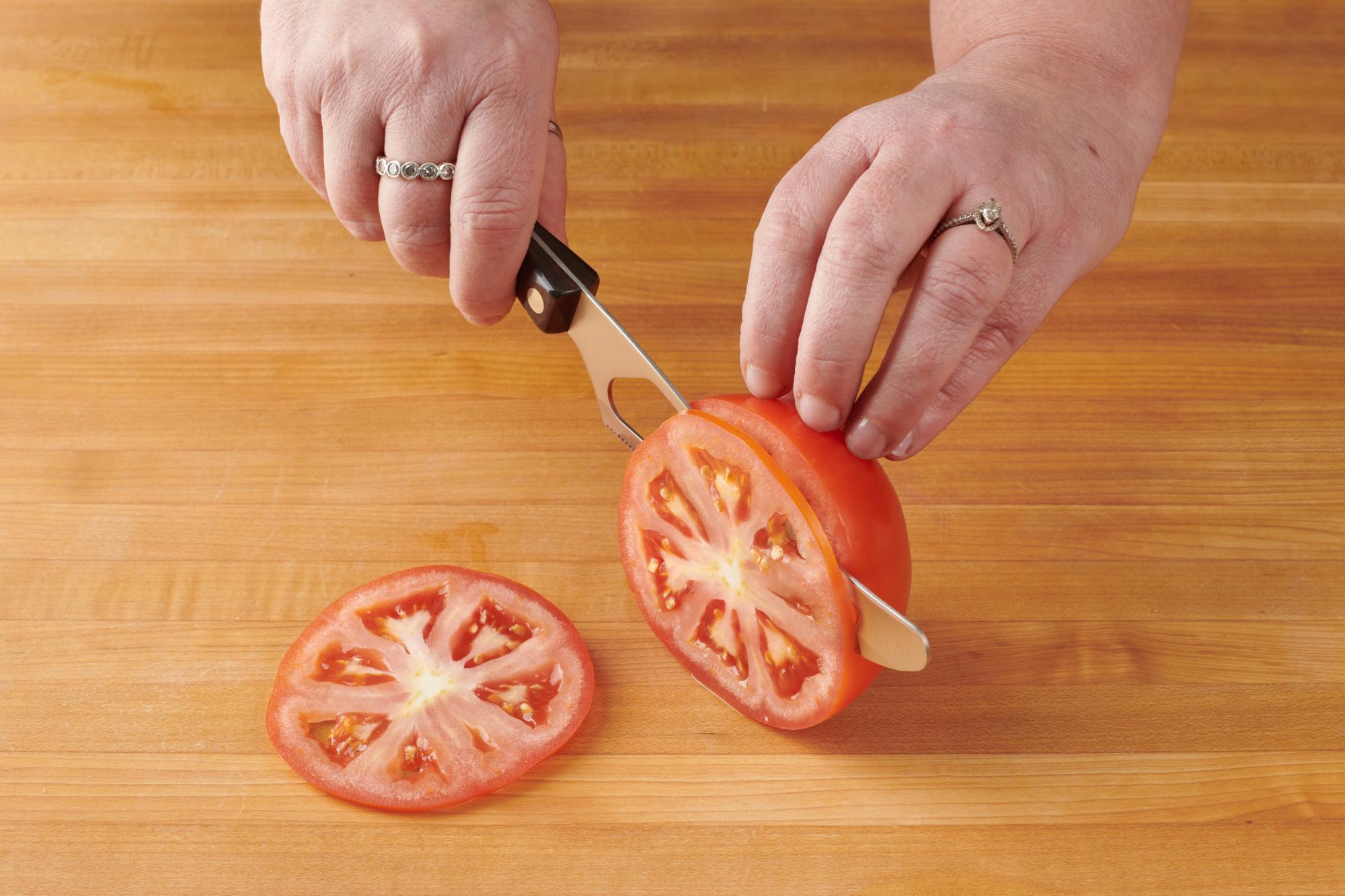 Thinly slicing tomato with a Traditional Cheese Knife.