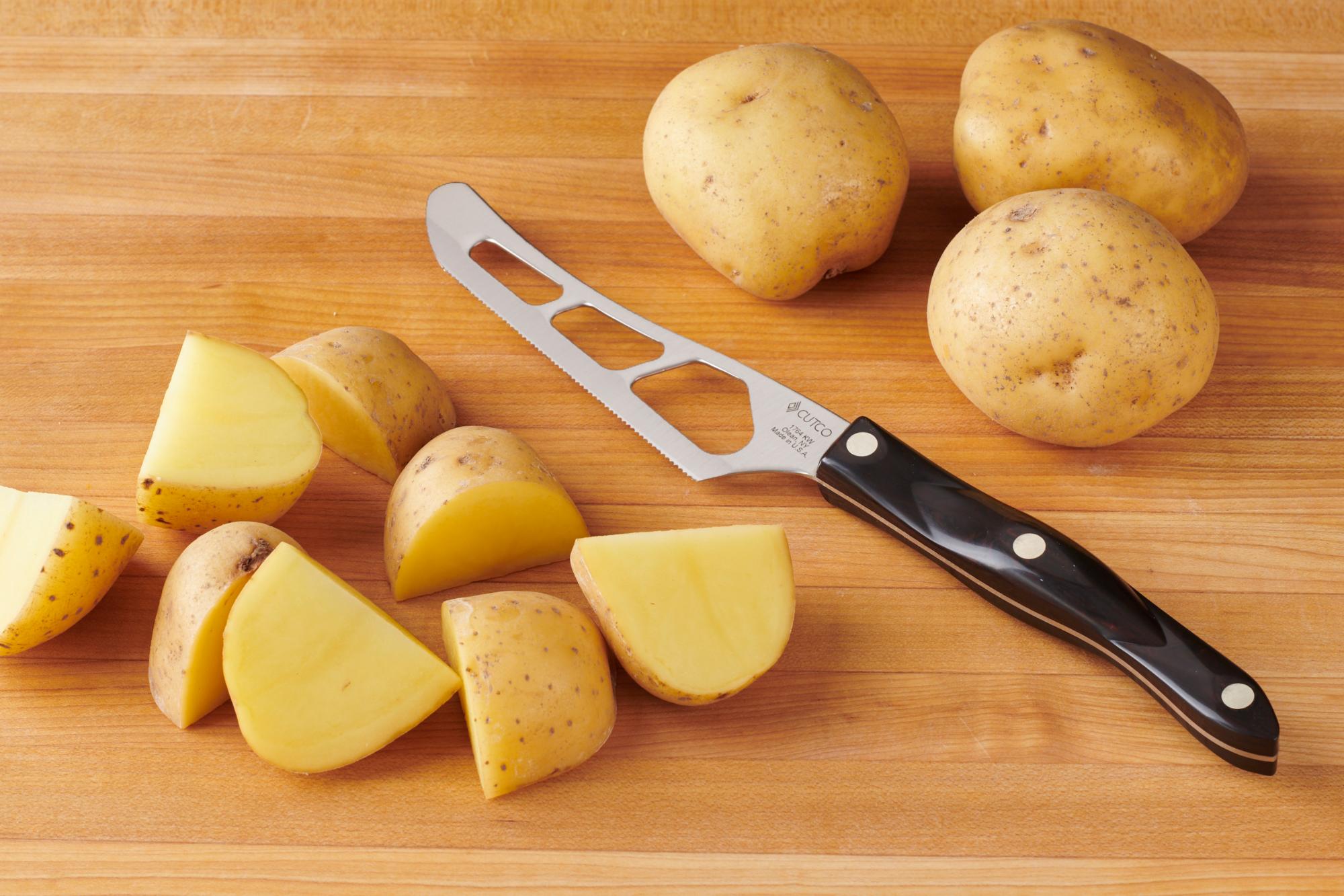 Quartered potatoes with a Traditional Cheese Knife.
