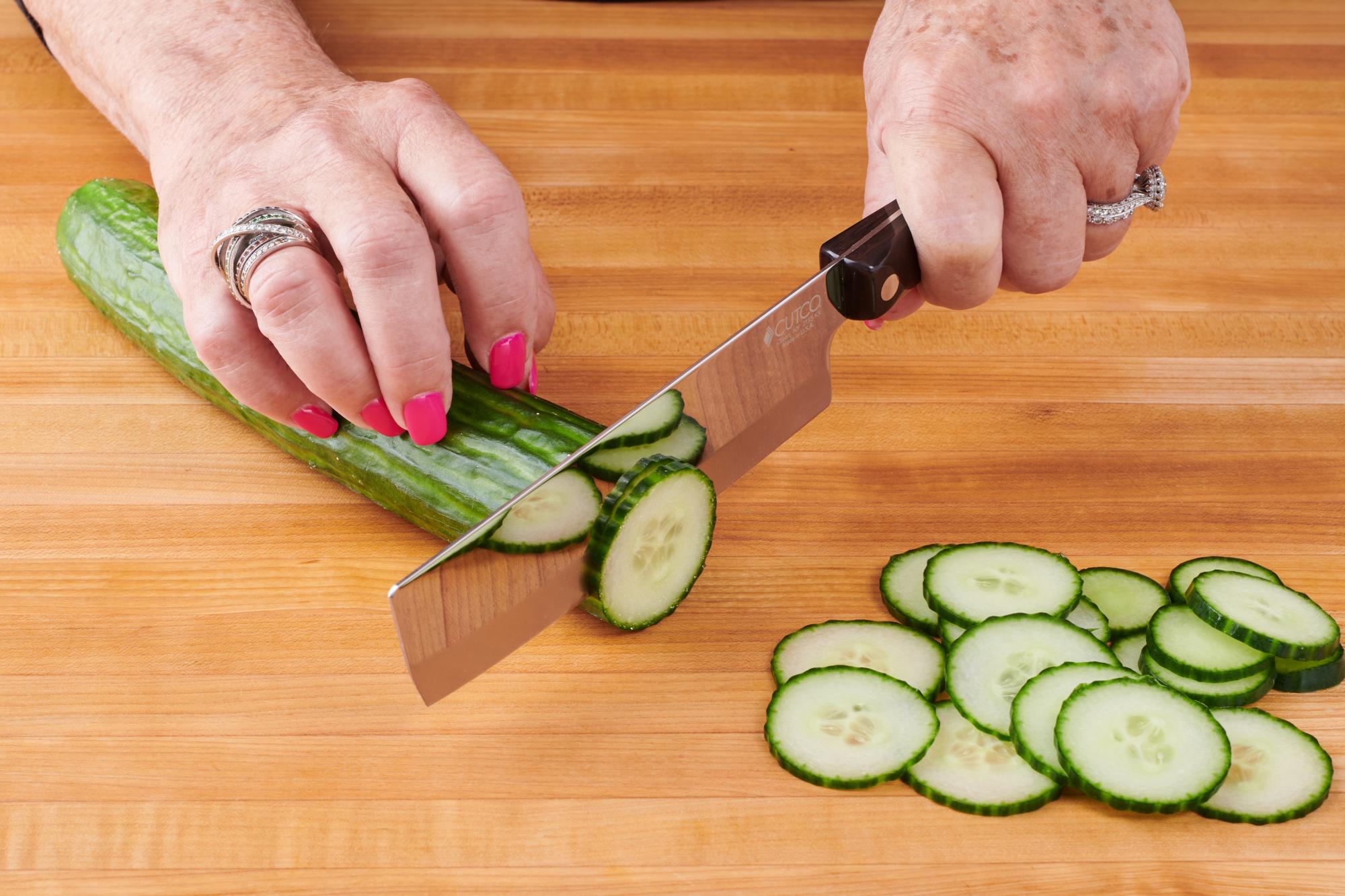 Slicing cucumber with a 6 Inch Vegetable Knife.