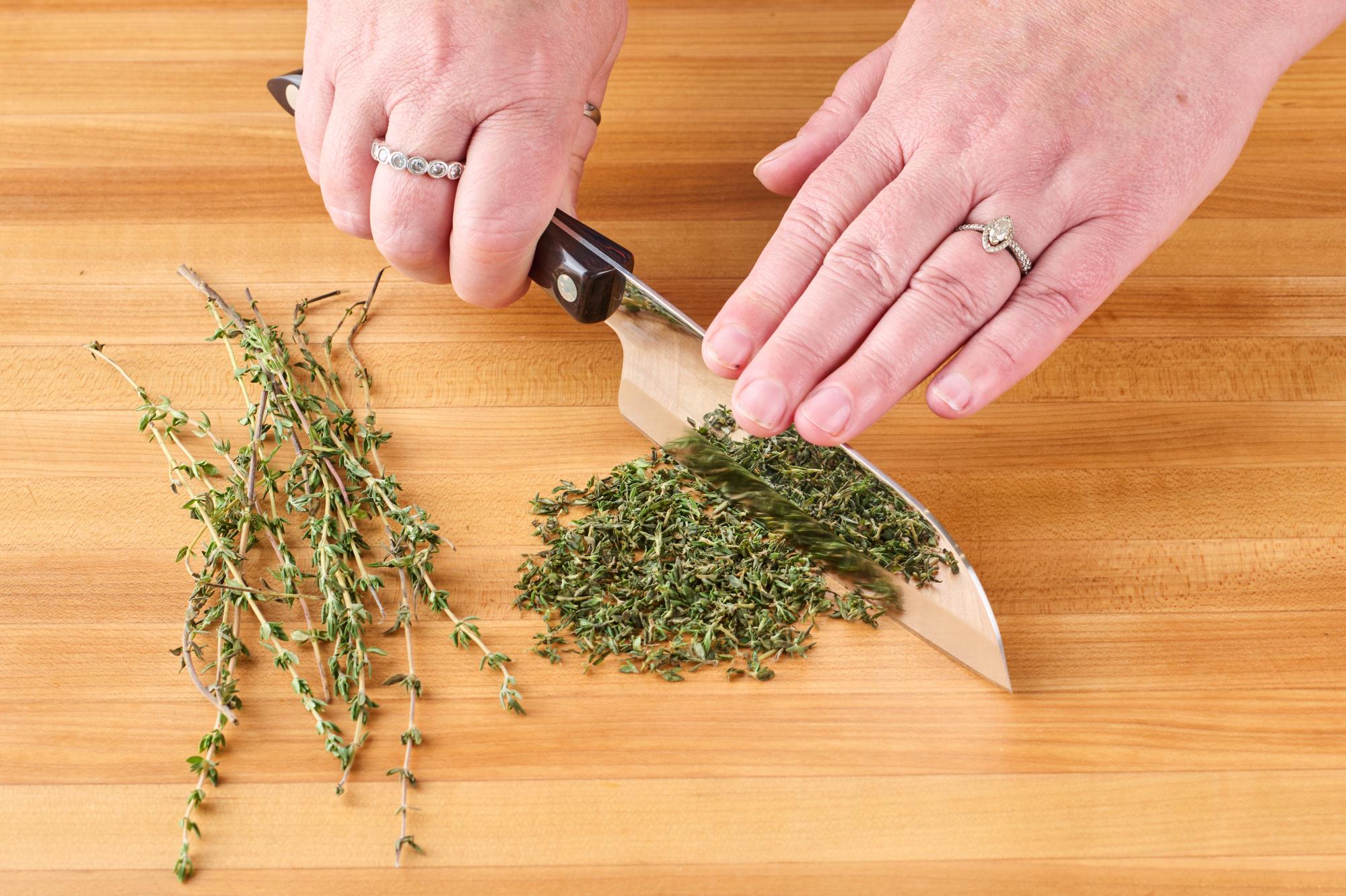 Chopping thyme with 5″ Petite Santoku