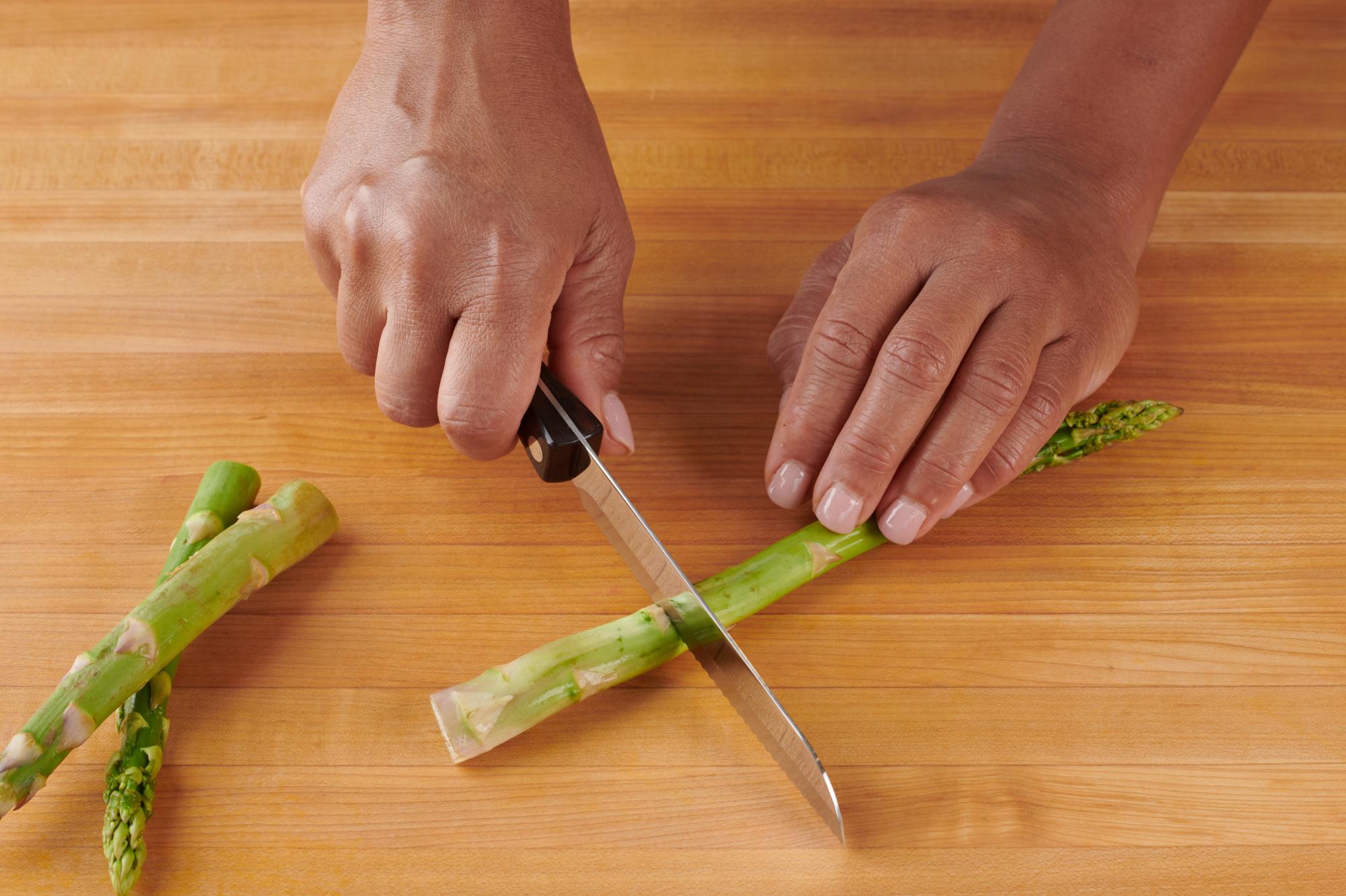 Trimming the asparagus with a Santoku-Style Trimmer.