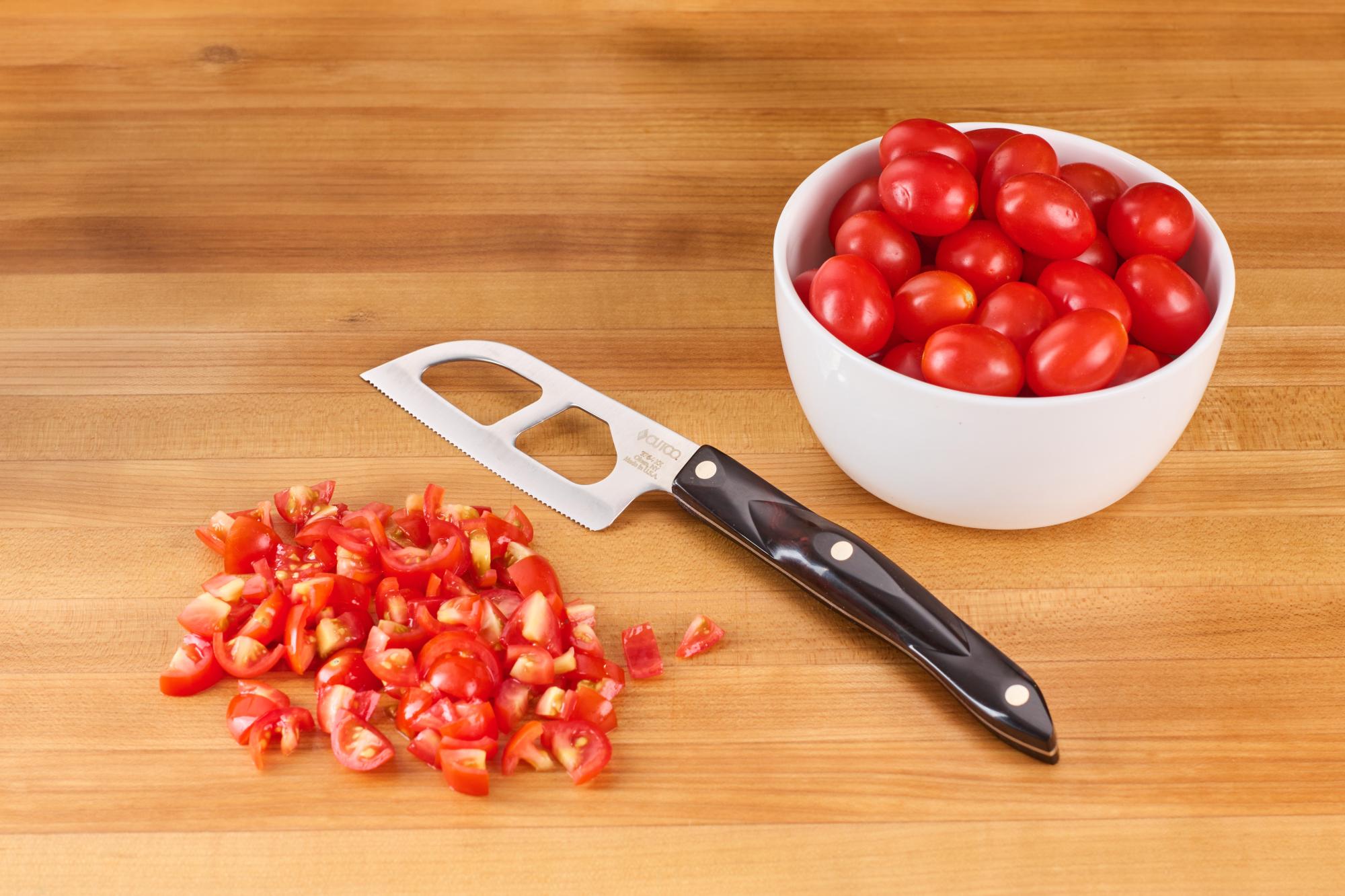 dicing the grape tomatoes with the Santoku-Style Cheese Knife