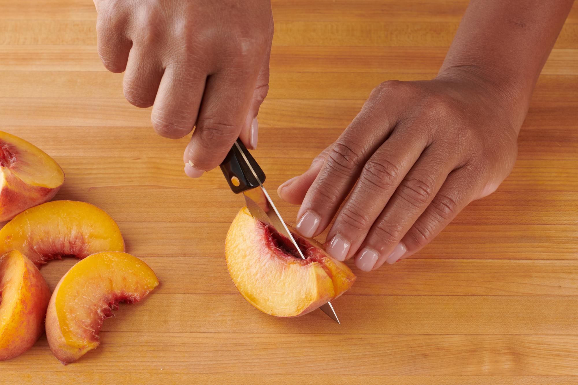 Slicing the peaches with a 3 Inch Gourmet Paring Knife.