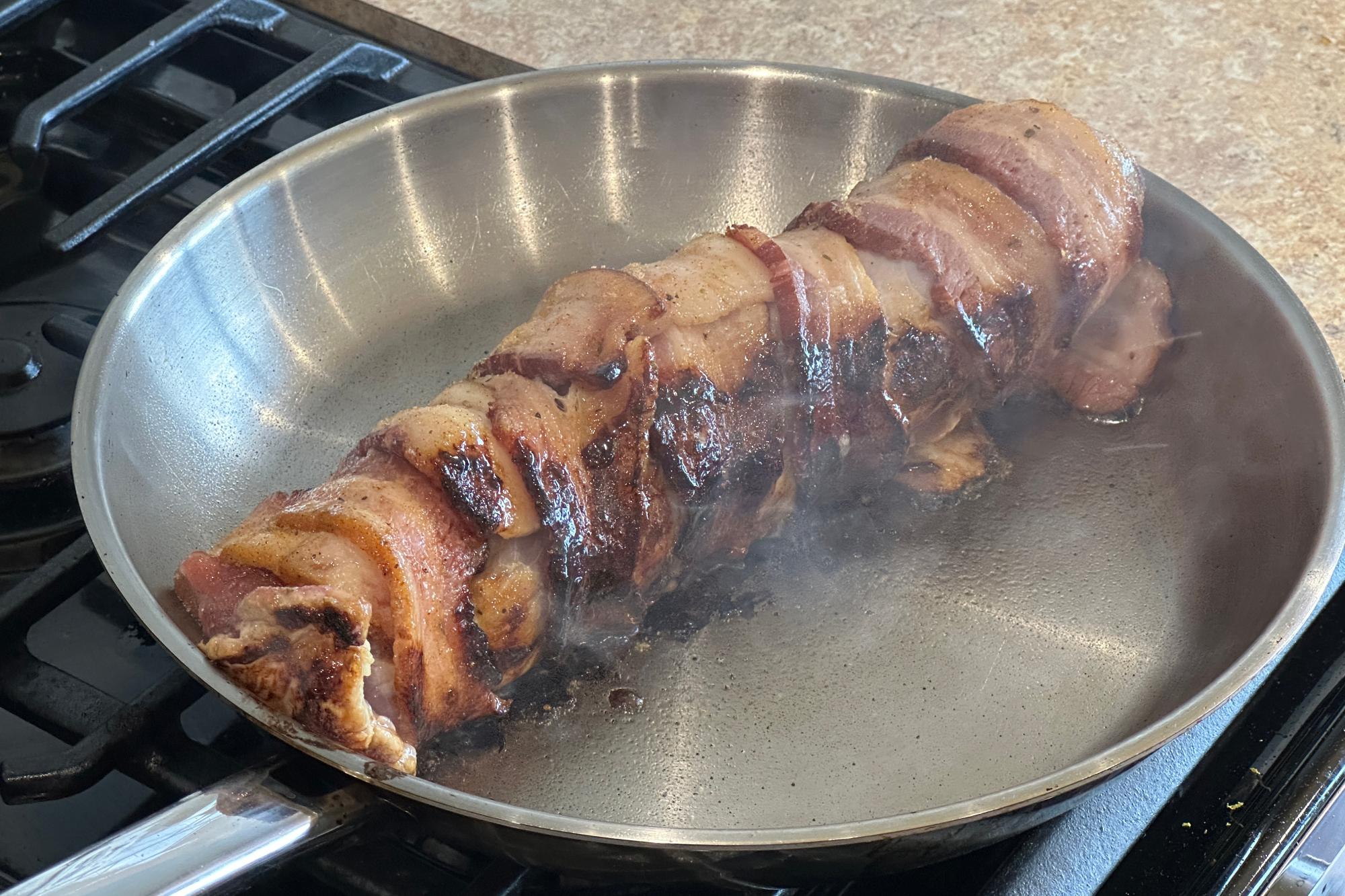 Searing pork in pan.