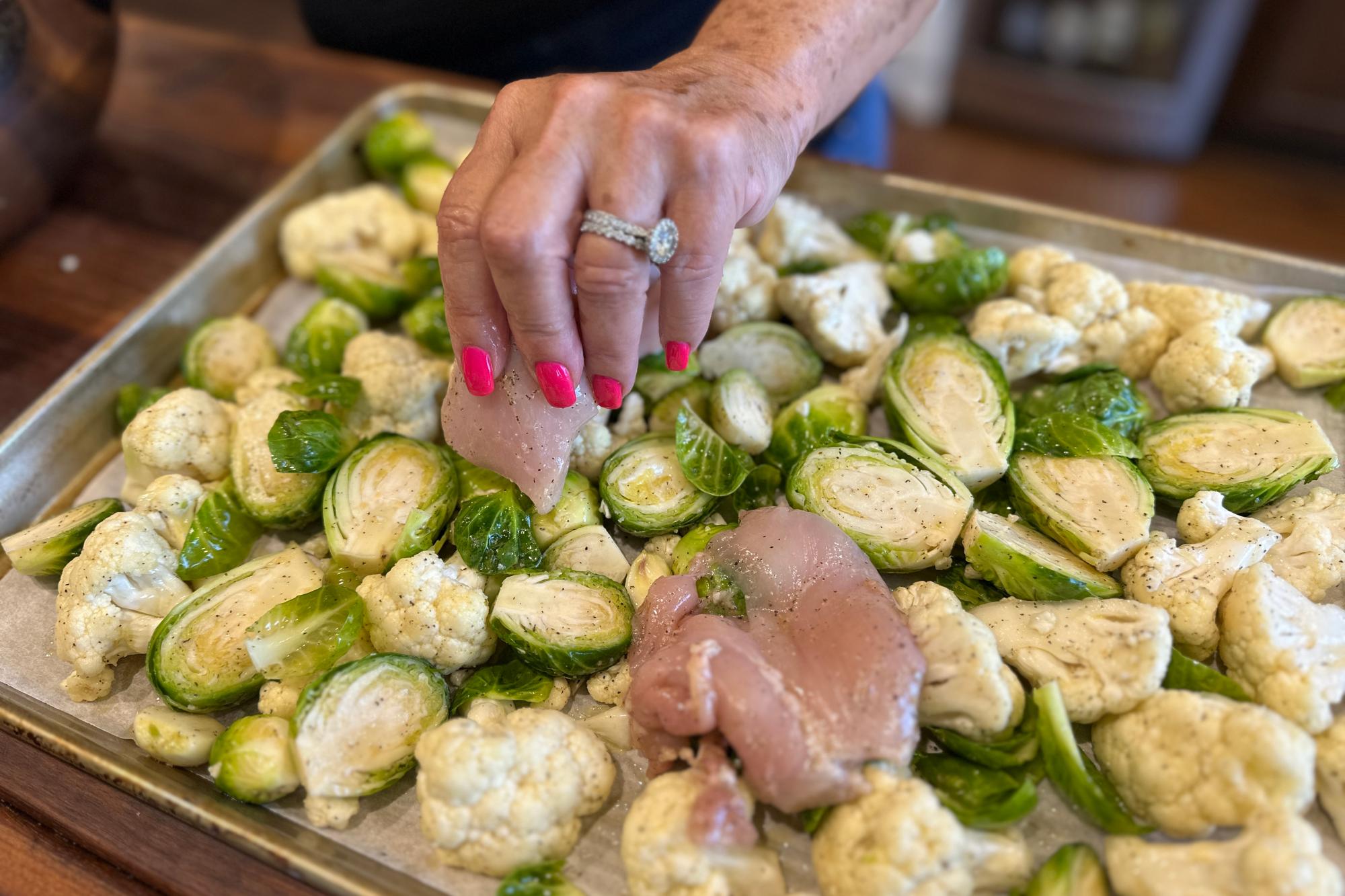 Placing chicken on the pan.