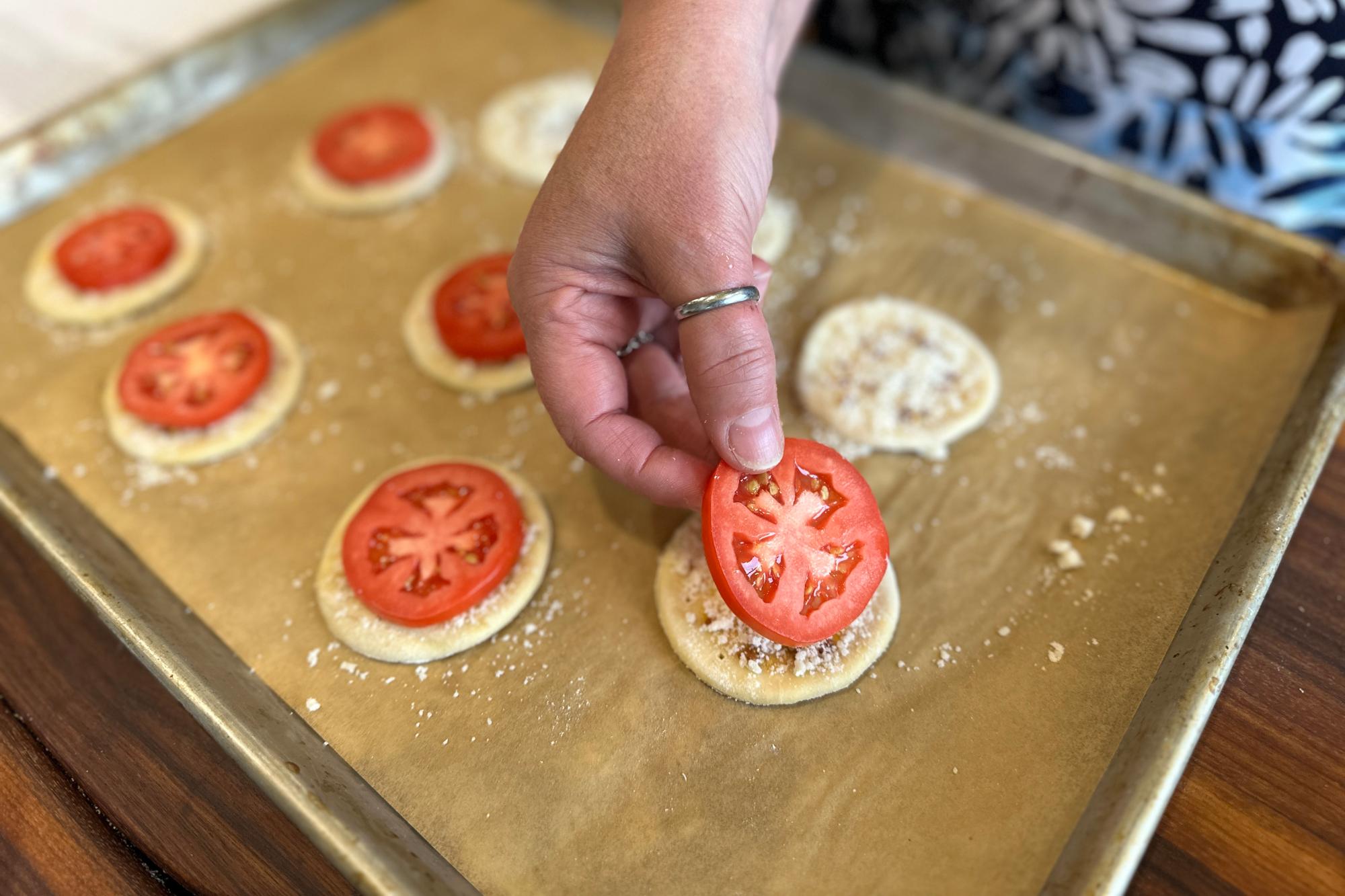 Placing a tomato on top.