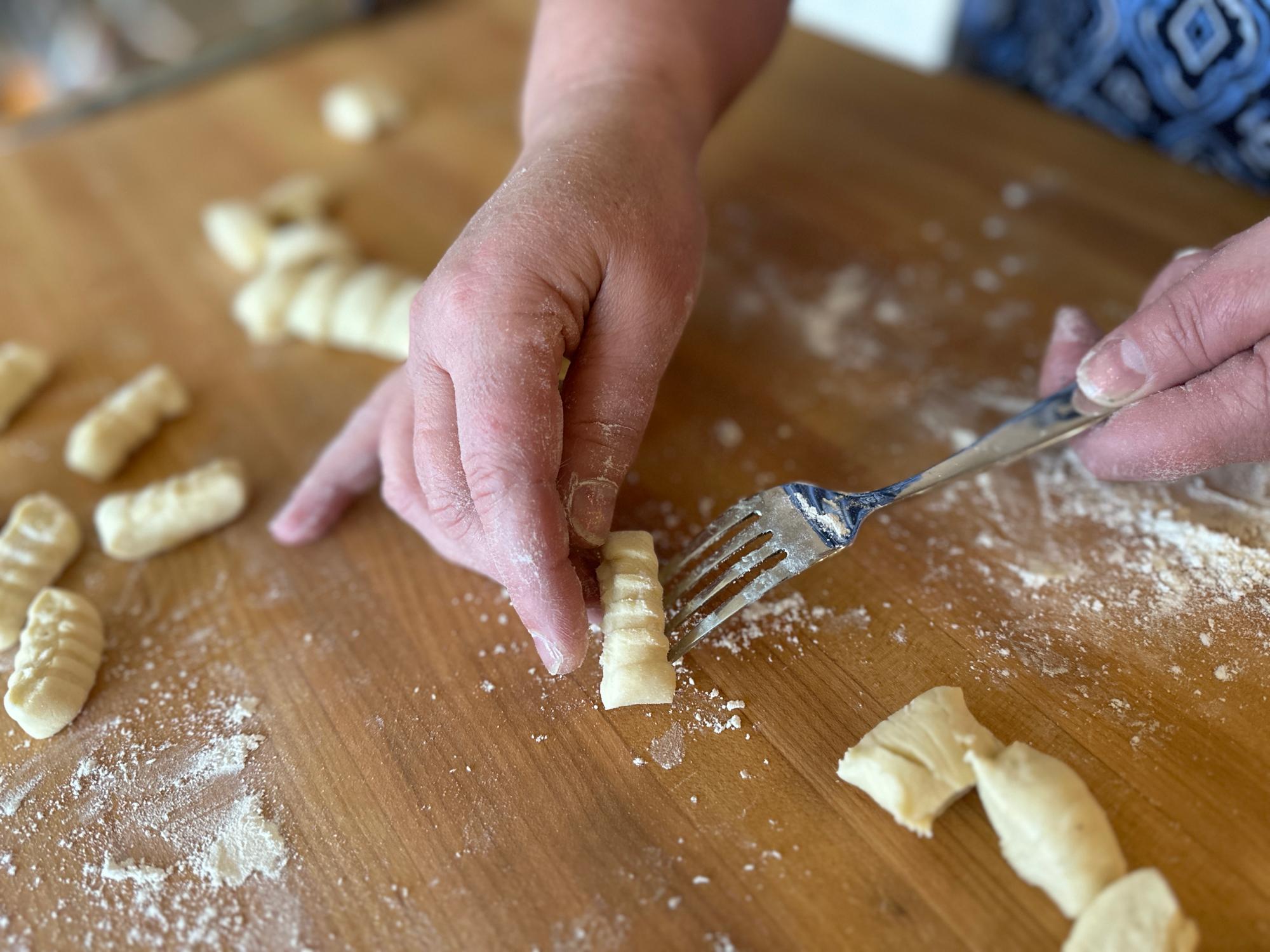 Marking the gnocchi with a fork.