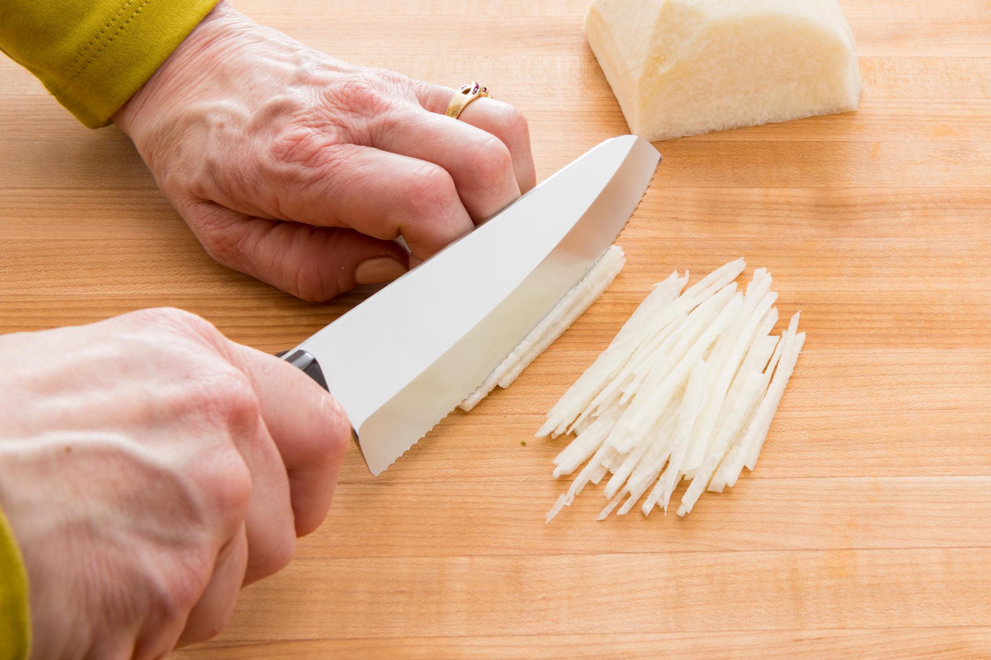 Cutting Jicama into matchsticks.