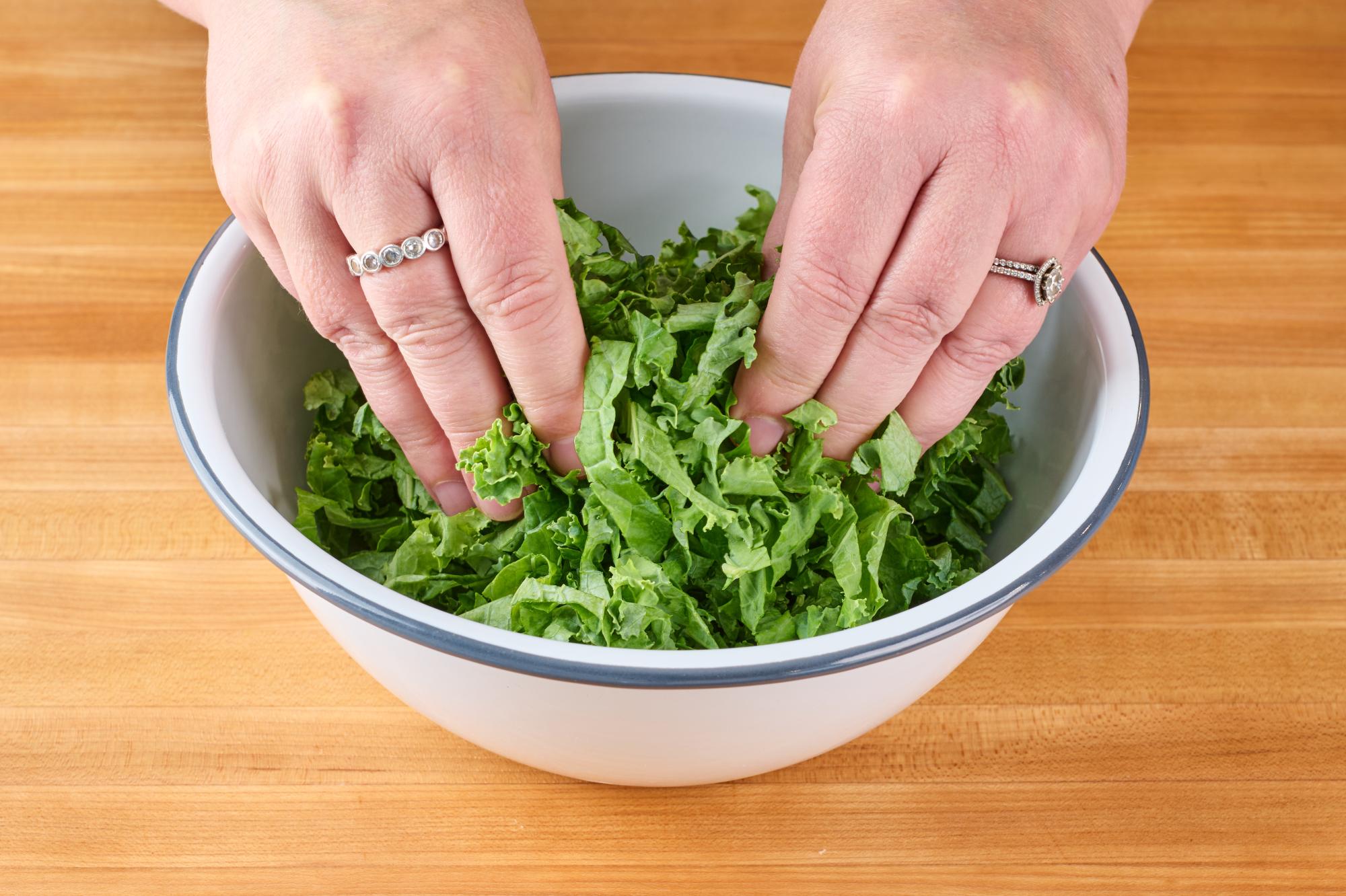 Massaging kale with hands