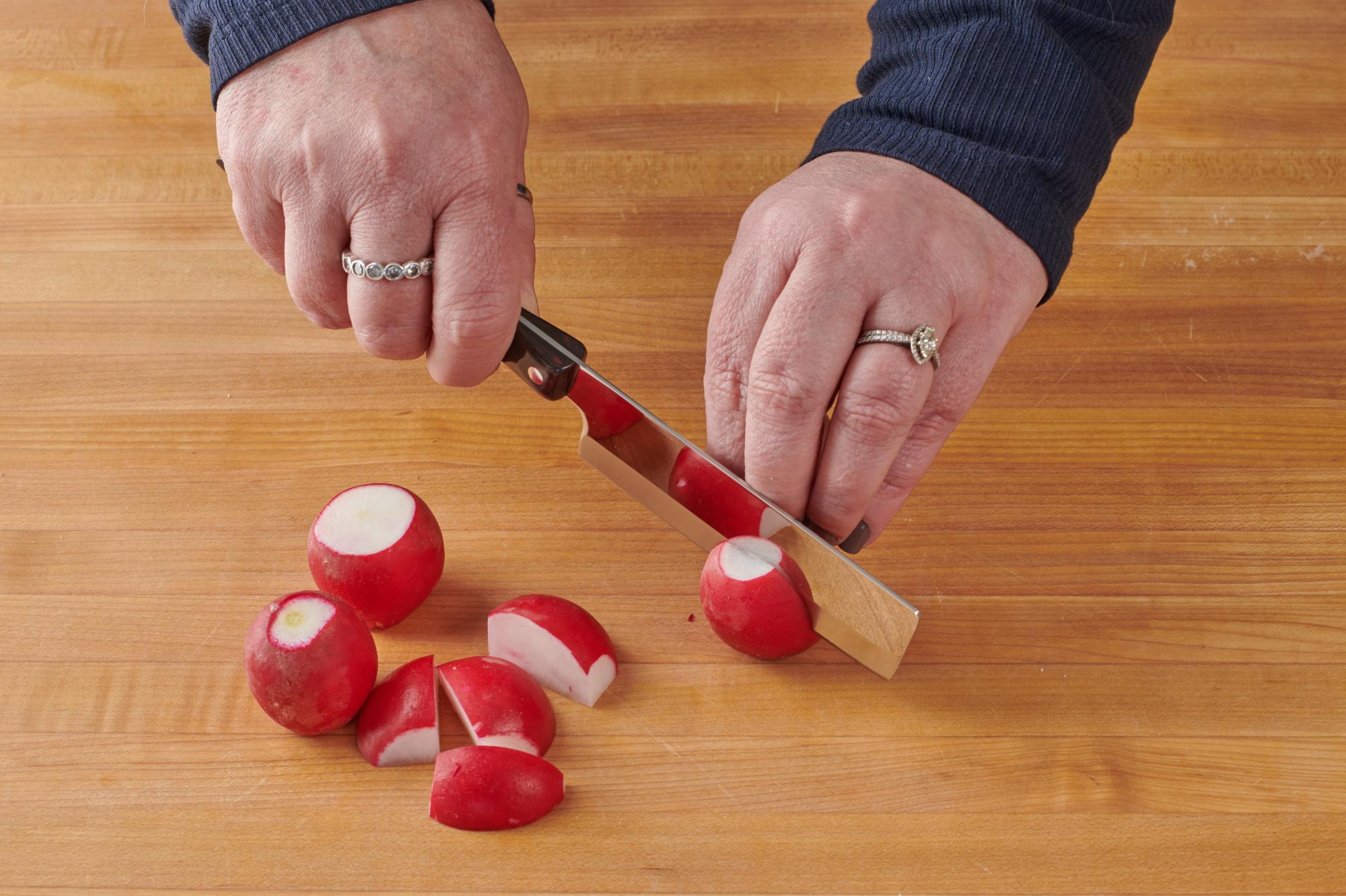 Slicing the radish with a 4 Inch Vegetable Knife.