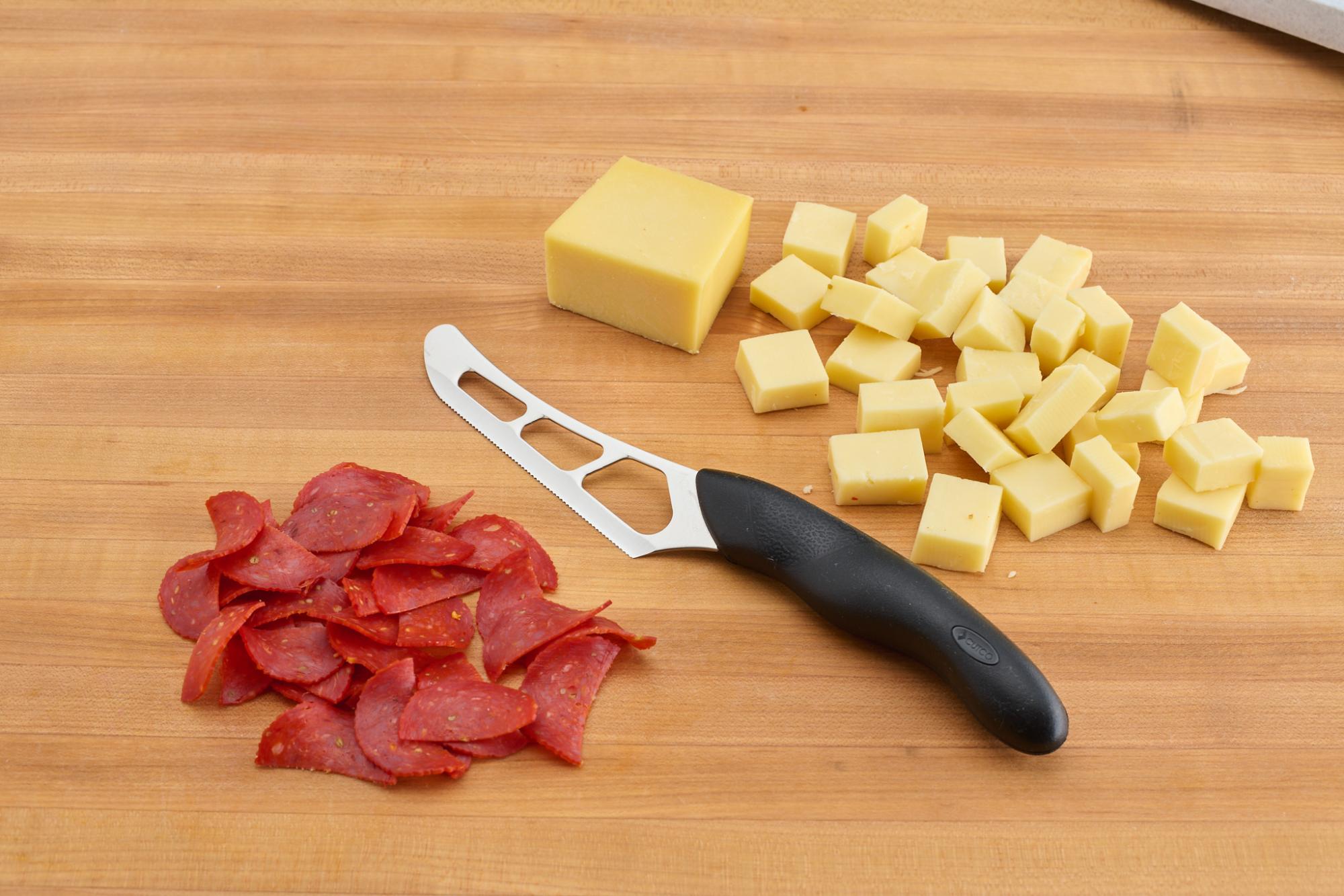 Cubed Gruyere and halved pepperoni with Cheese Knife