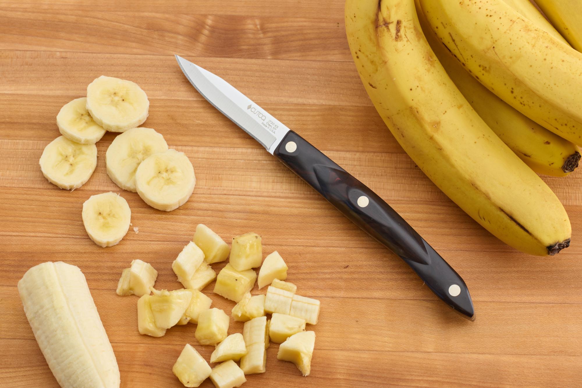 Sliced banana with a paring knife.