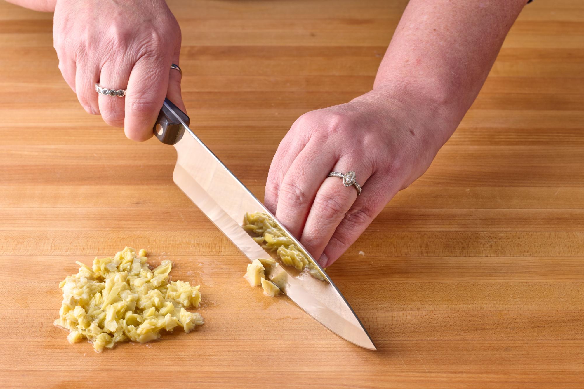 Finely chopping artichoke hearts with Petite Chef.