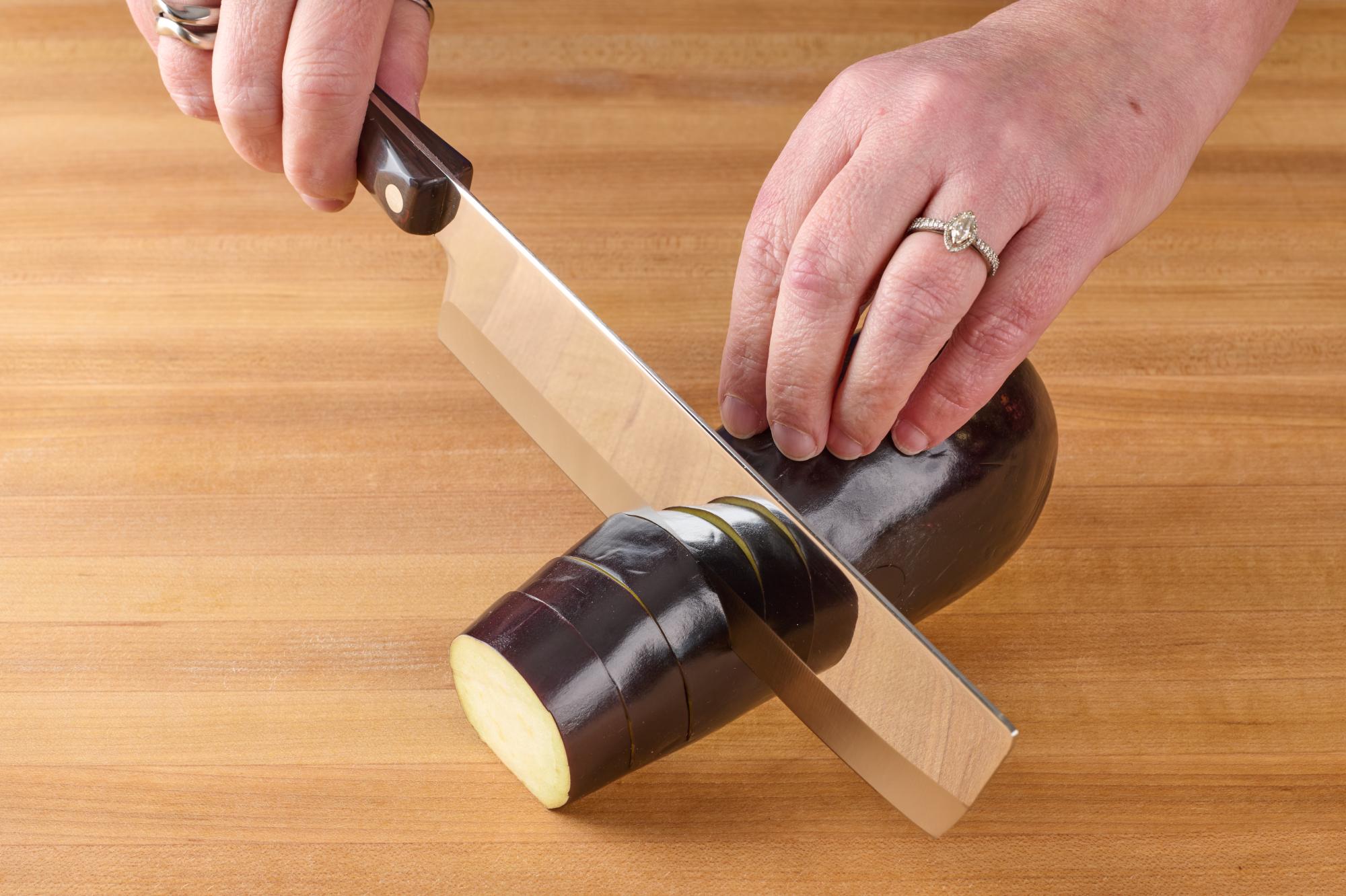 Make slices along the length of the eggplant.