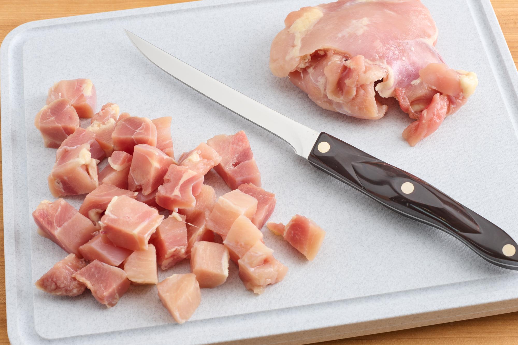 Cubed chicken with Boning Knife.