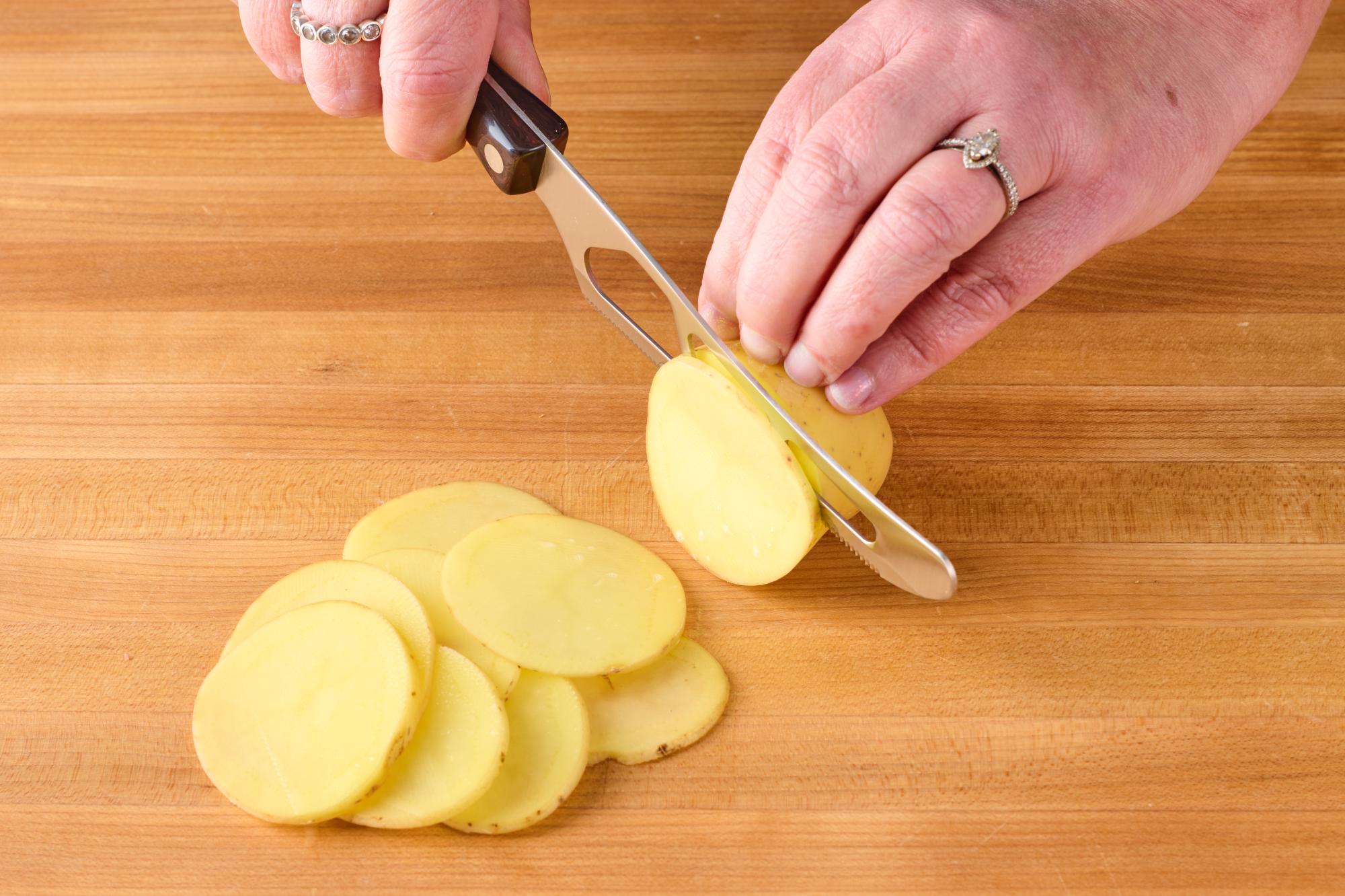 Slicing the potatoes with a Traditional Cheese Knife.