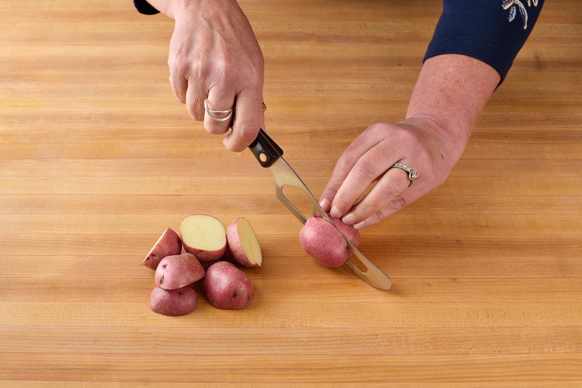Halving baby red potatoes with Traditional Cheese Knife