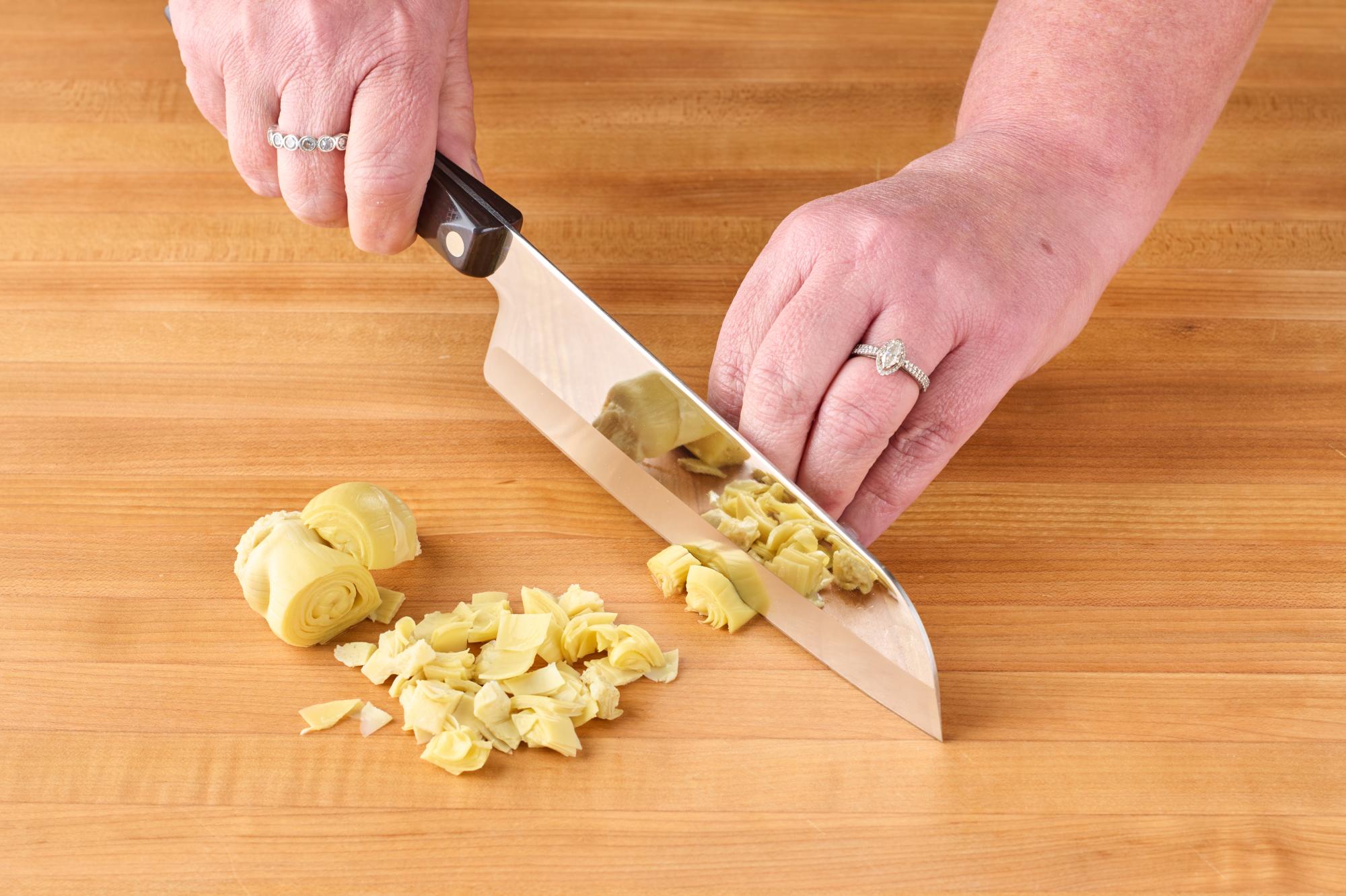 Chopping artichoke hearts with Santoku