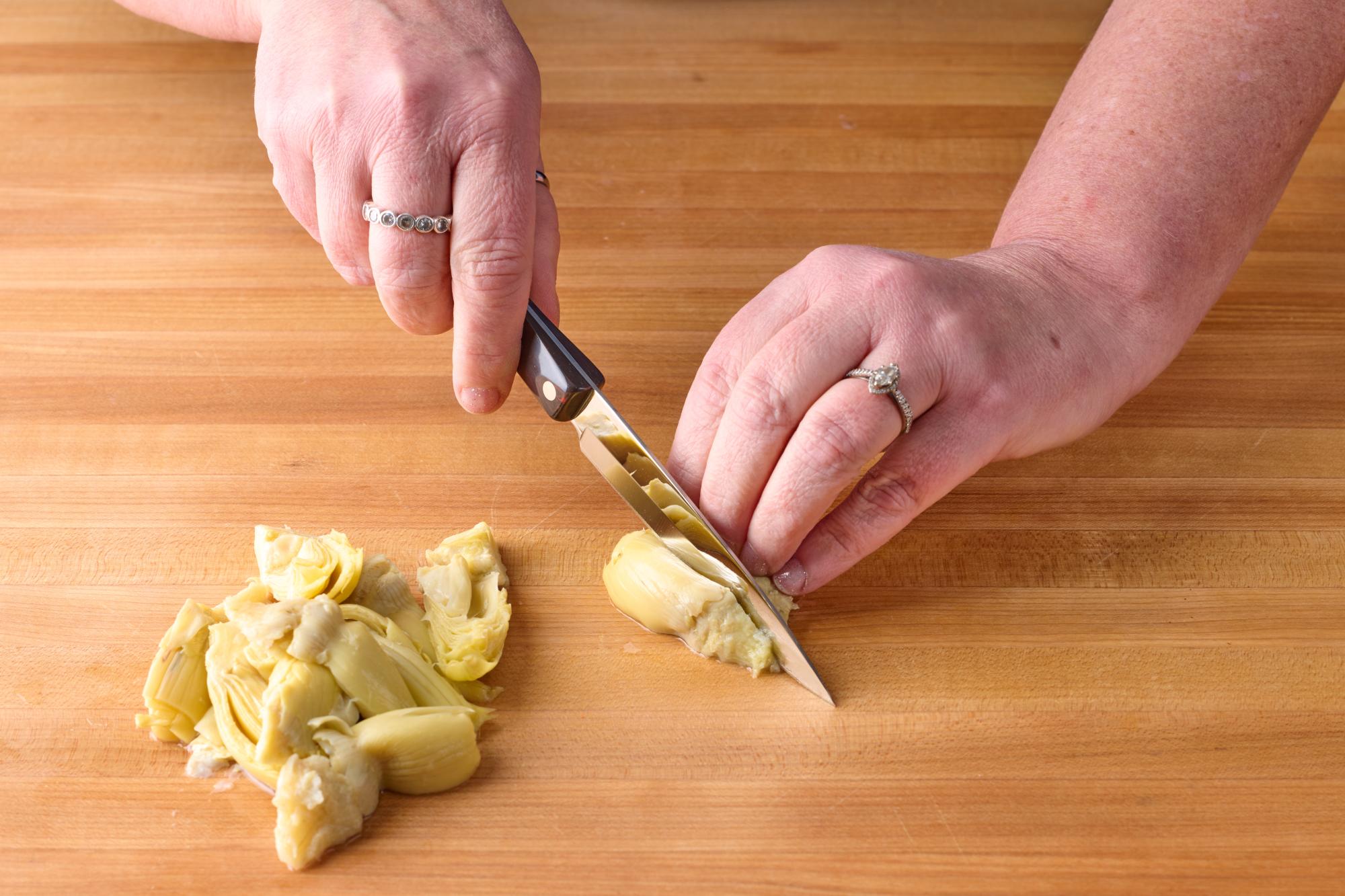 Quarter the artichoke hearts with a 4 Inch Paring Knife.