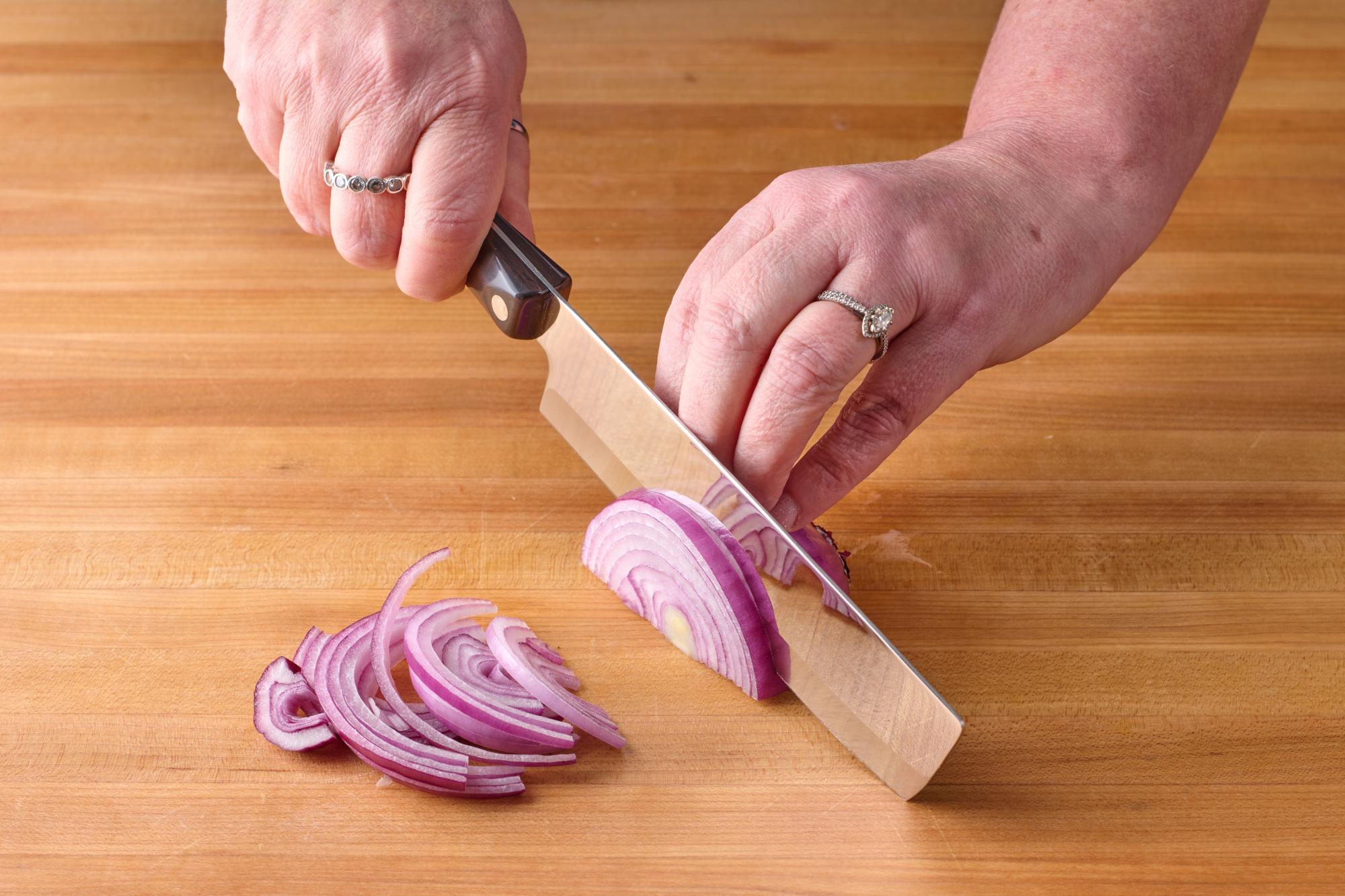 Cutting the red onion with the 6 inch Vegetable Knife.
