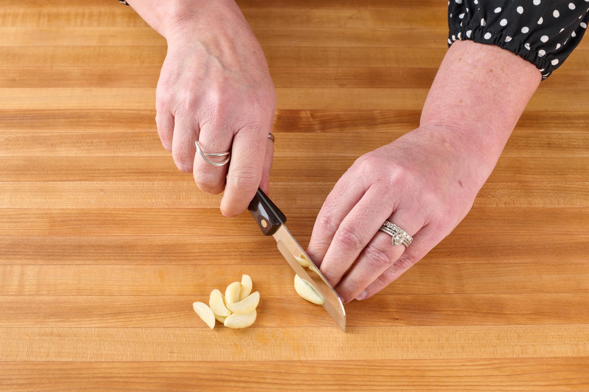 Slice garlic using the Santoku-Style 3 Inch Paring Knife.