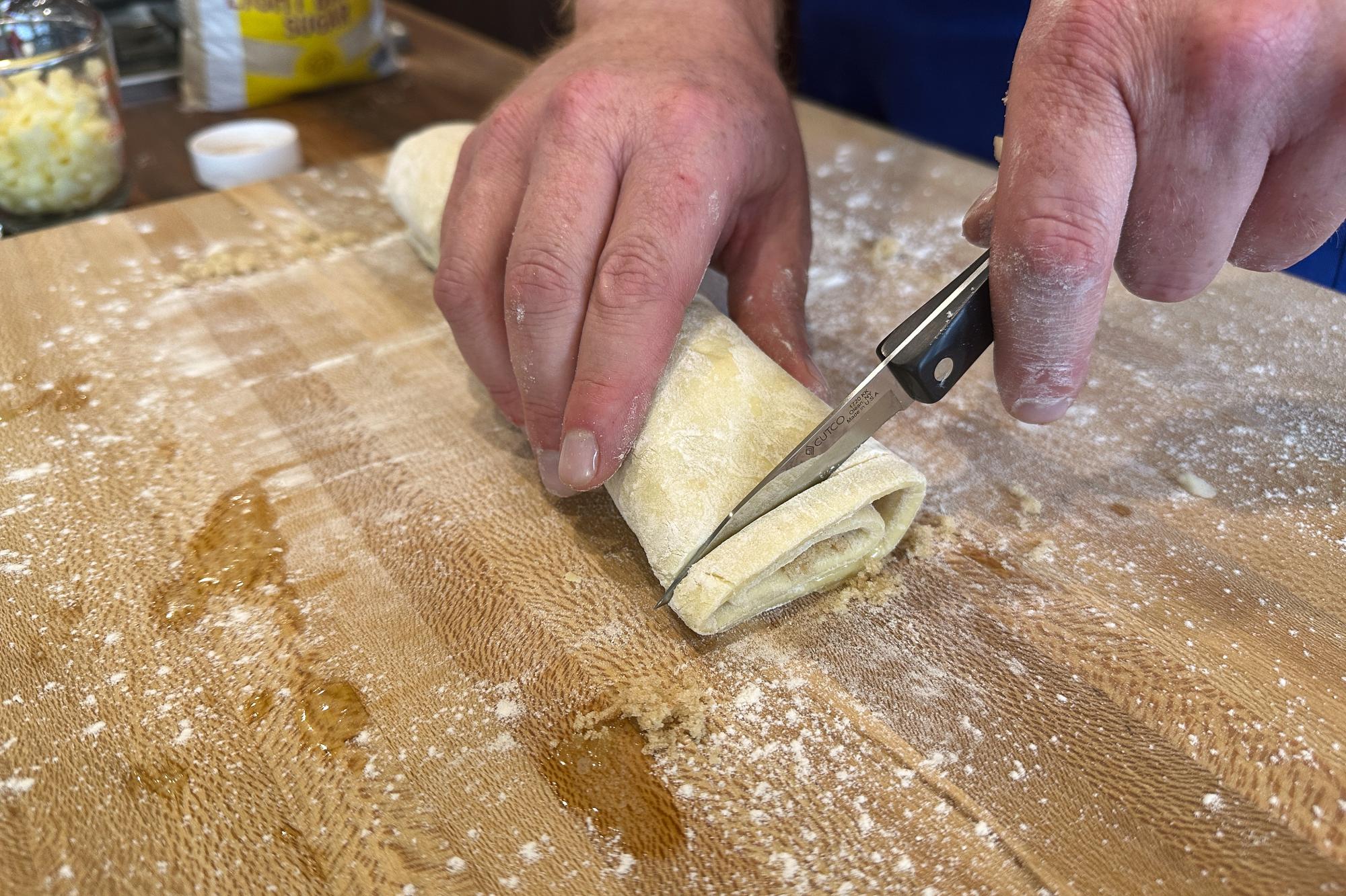 Trimming the ends of the roll with a Paring Knife.