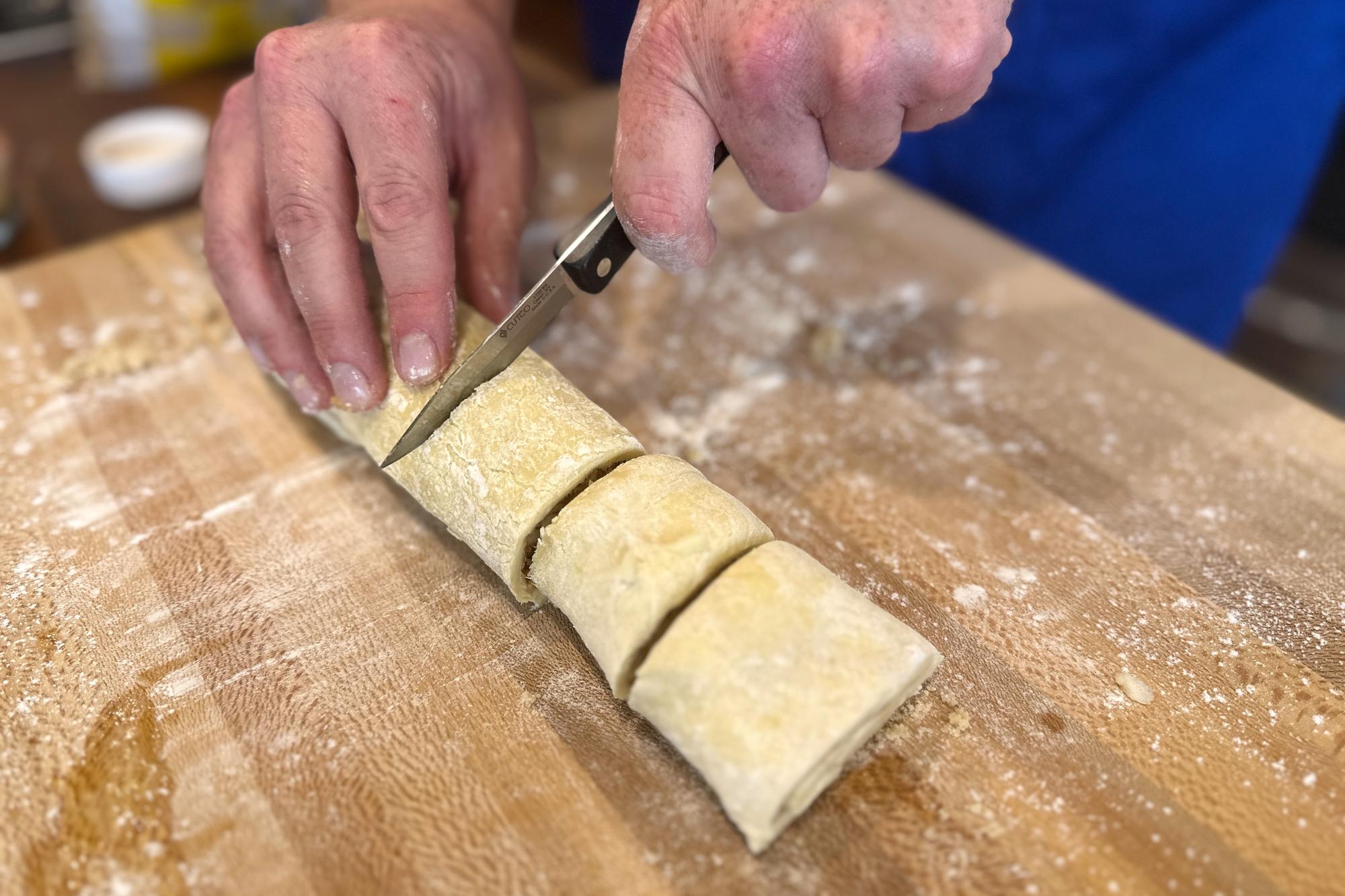 Slicing the roll with a Paring Knife.