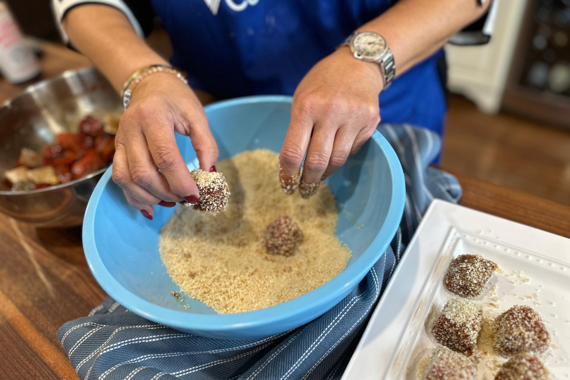 Coating the salmon in breadcrumbs.