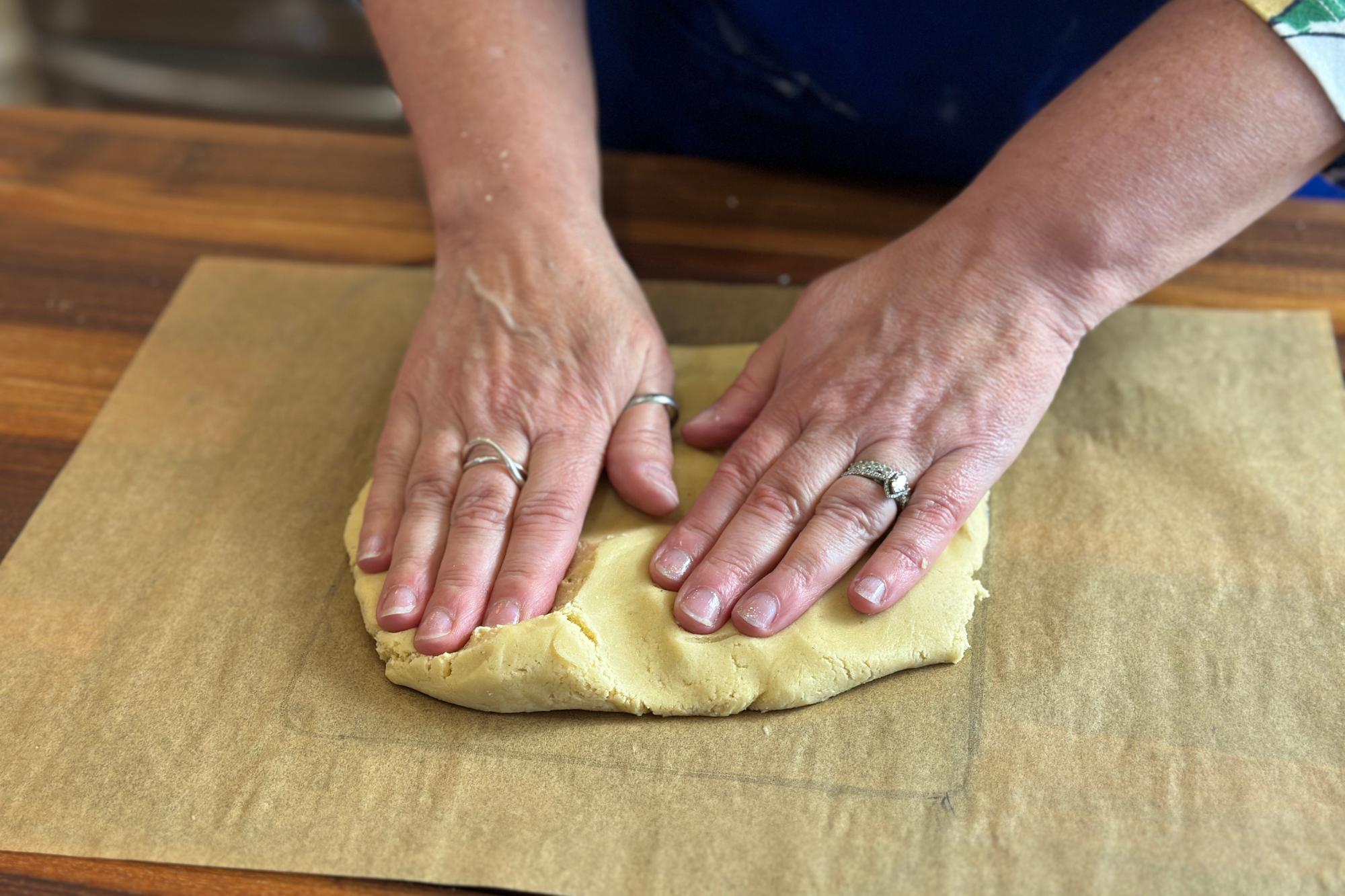 Pressing the dough out in to a square.