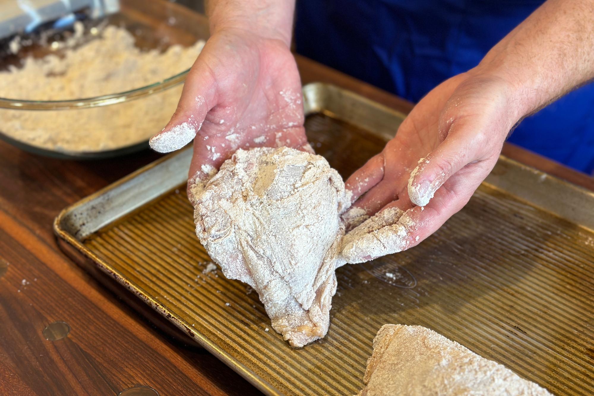 Placing the chicken on the pan.