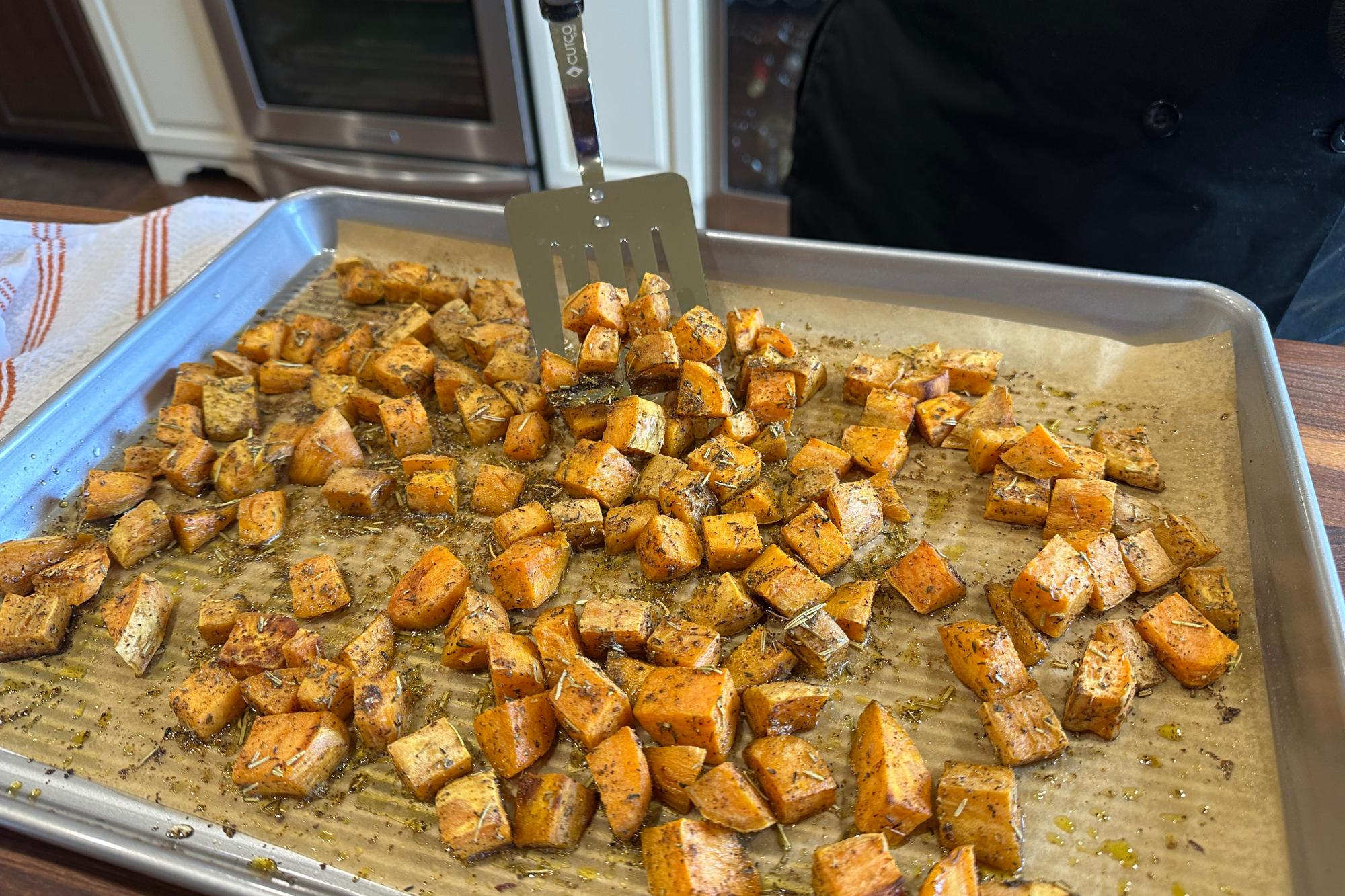 Flip the sweet potato cubes with a Slotted Turner.