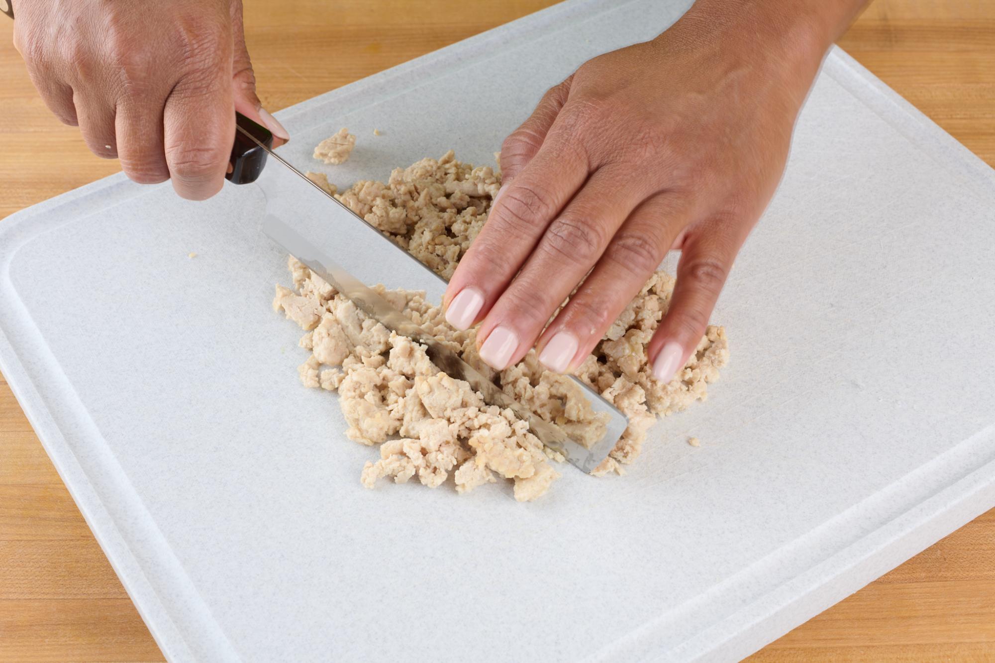 Finely chopping cooked chicken