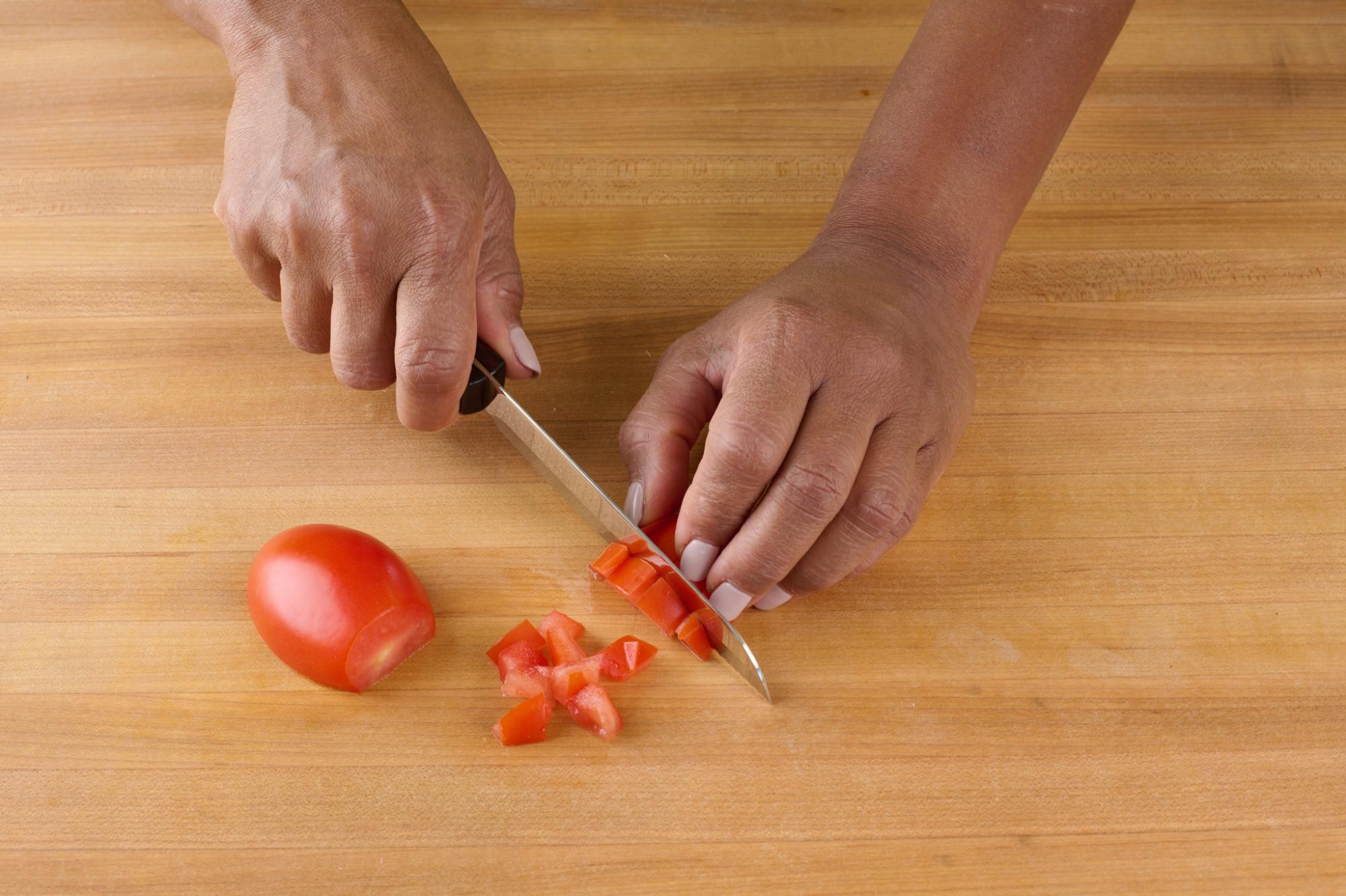 Dicing plum tomato with Santoku Style Trimmer.